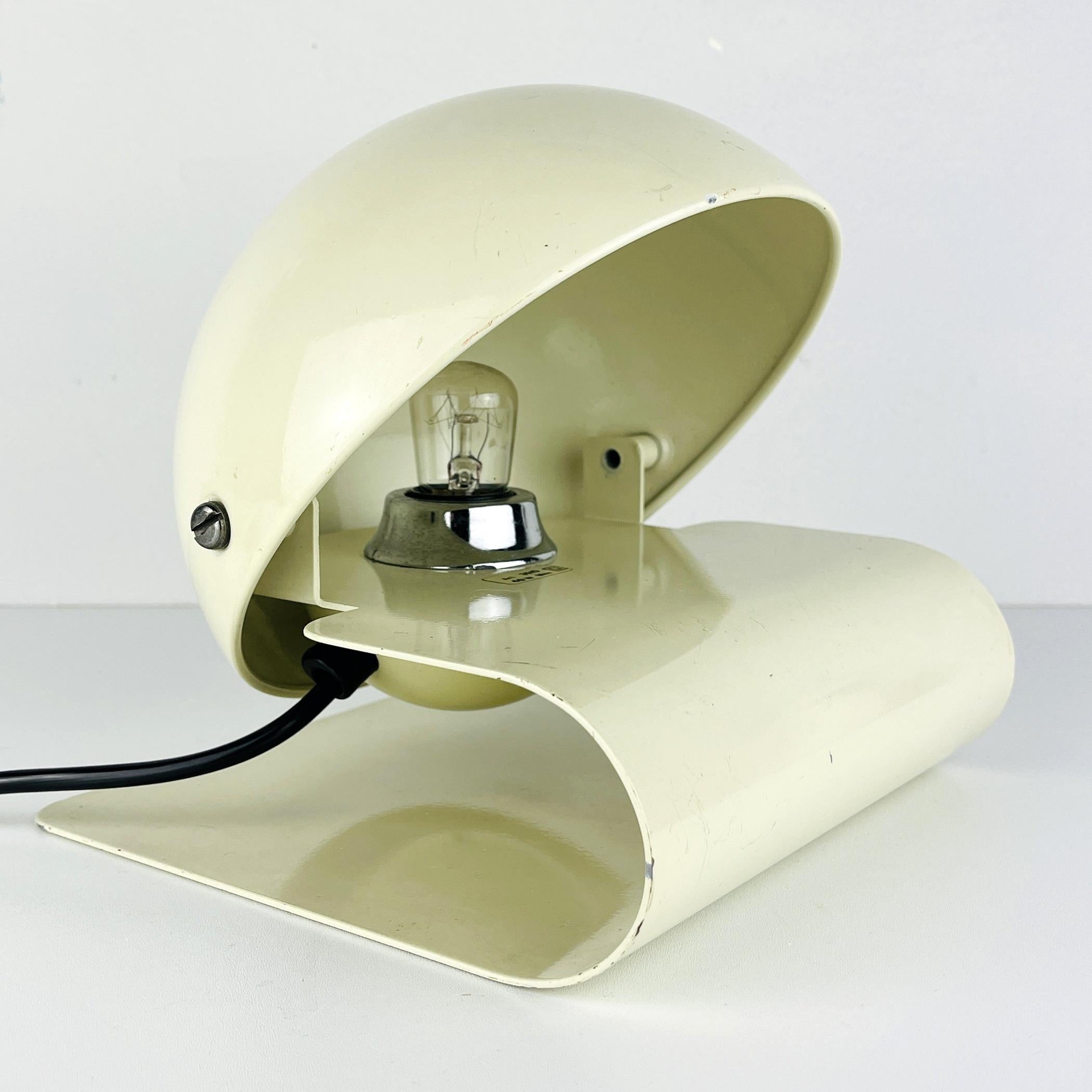 Mid-century metal table lamp by Giuseppe Cormio for iGuzzini Italy 1970s. Giuseppe Cormio designed the Bugia table lamp for the 1975 Milan Fair. A year later, it was put into production. White painted folded curved metal base. Half round metal