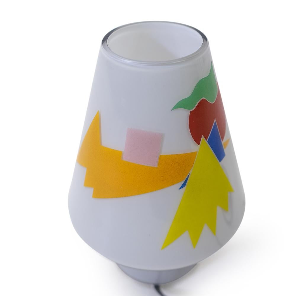 Memphis-Milano style glass table lamp “Bibi” by Alessandro Mendini, produced by Artemide as part of the Sidecar line.

The glass housing is handmade and features nice colorful graphics, when turned on it produces a soft glow.

 

Origination: