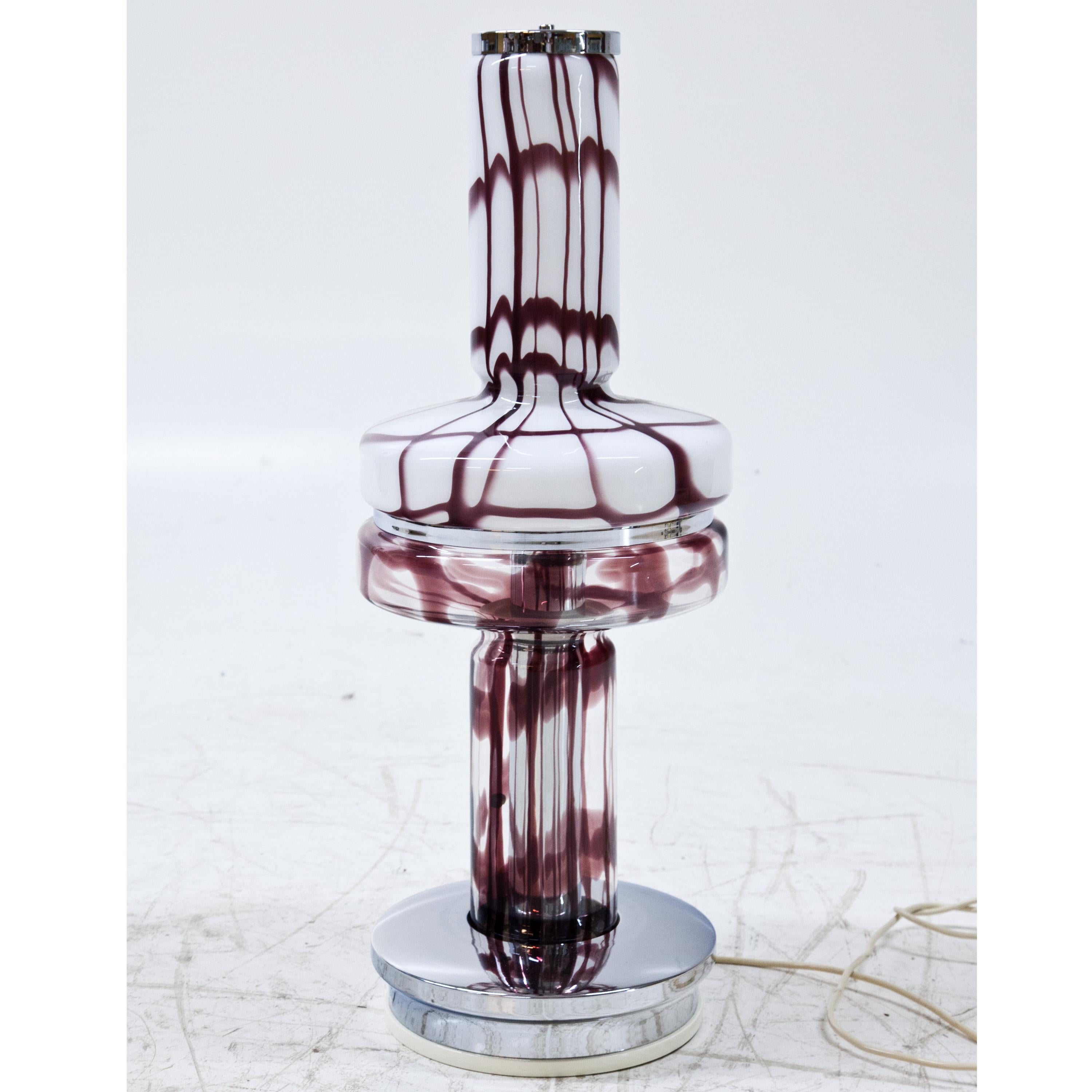 Table lamp by Angelo Brotto out of purple and white Murano glass on top and purple and transparent Murano glass at the bottom, as well as chromed elements. The lamps stand on a round base and were rewired. Label by Esperia and Murano on the glass