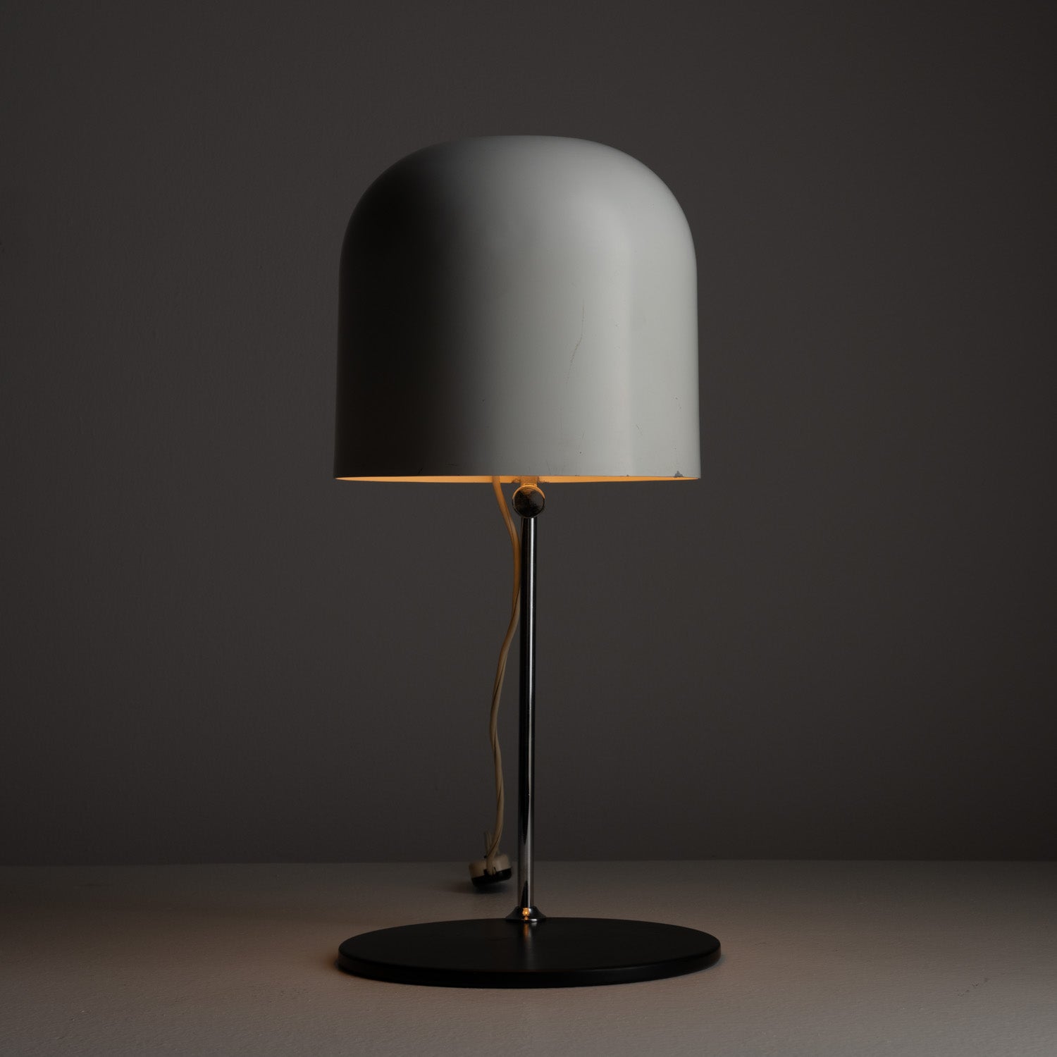 Table Lamp by Angelo Ostuni for Oluce. Designed and manufactured in Italy, circa the 1970s. In true form of other Oluce's 60s and 70s pieces, this table lamp's functionality is at its peak. An original enameled shade has the ability to adjust at all