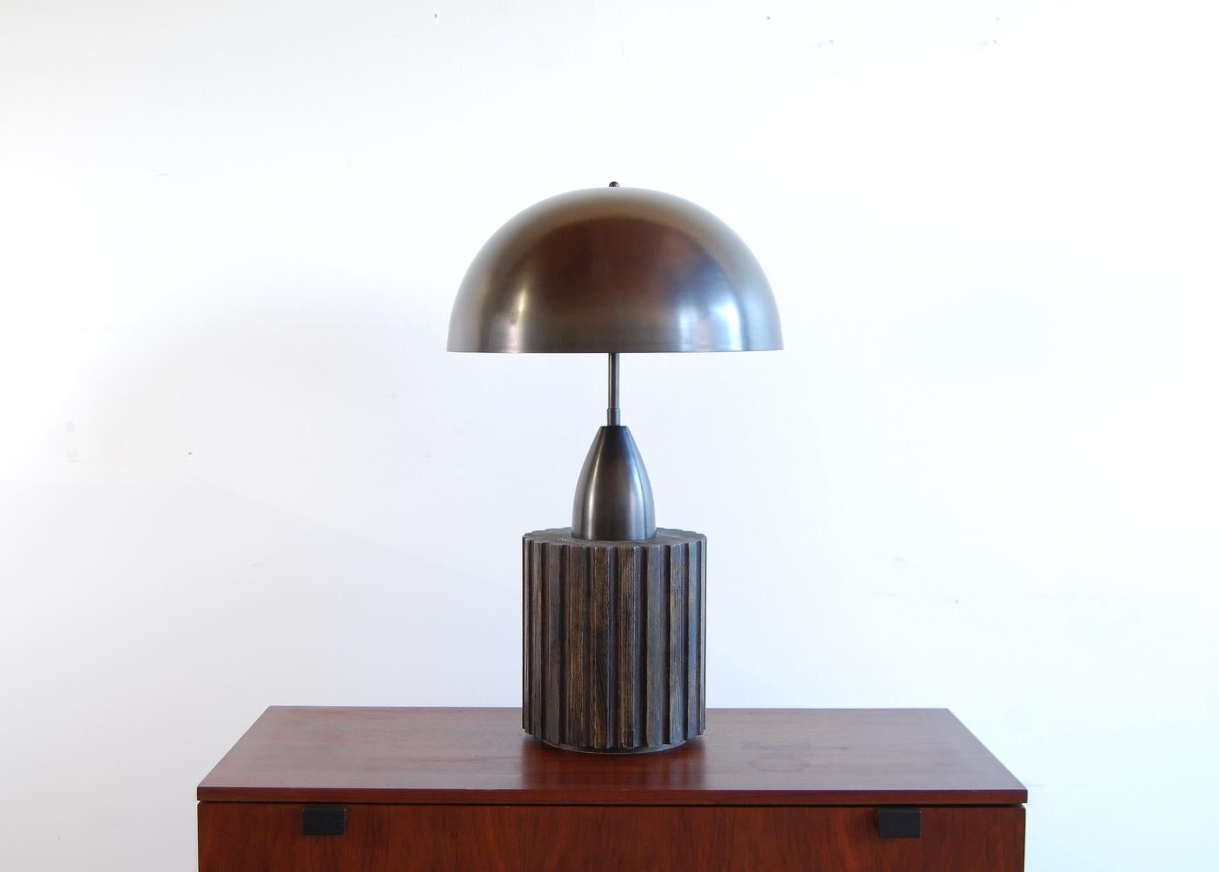 Large table lamp by Apparatus Studio, New York City. Solid, patinated brass, with a fluted solid oak base. 24