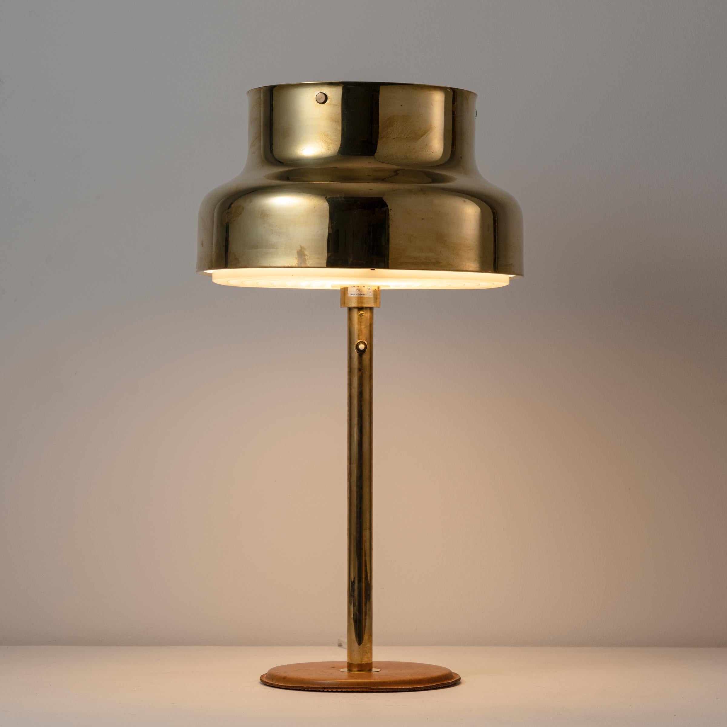 Table lamp by Atelje Lyktan. Designed and manufactured in Sweden. Brass shade, leather base. Original EU cord.
 Lamping: 120v 1Qty E27 75w maximum bulb. Bulb not included. Shade Height: 9.25