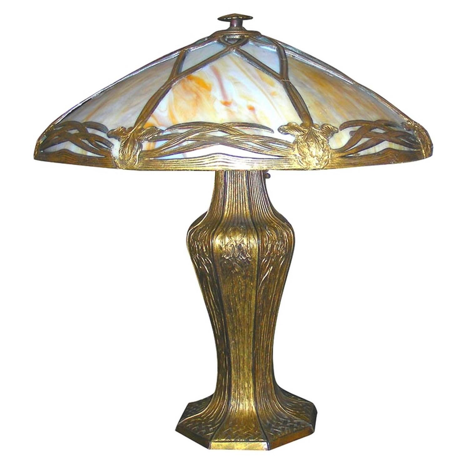 Bradley & Hubbard Arts & Crafts table lamp.

Lampshade with a rebated metal frame with iris decoration and curved slag glass panels.
It's stamped Bradley and Hubbard under the base of the lamp.
Beautiful colors when it is turned on and