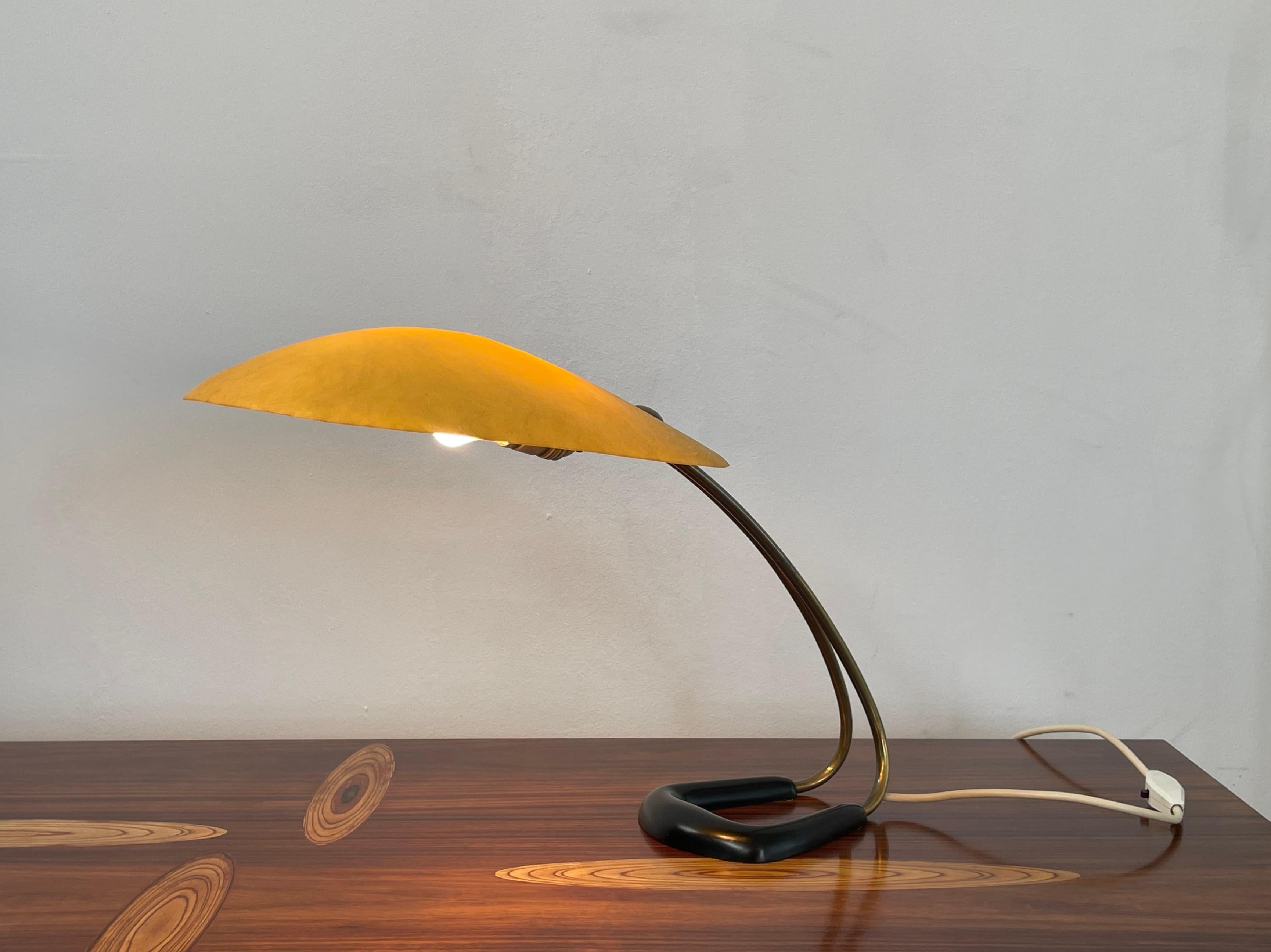 Beautiful table light by Carl Auböck, manufactured by the Werkstätte Carl Auböck in the 1950´s.

Yellow fiberglas shade in fantastic condition. Cast iron base black enameled. Bend brass poles with beautiful patina.

Original wiring and switch in
