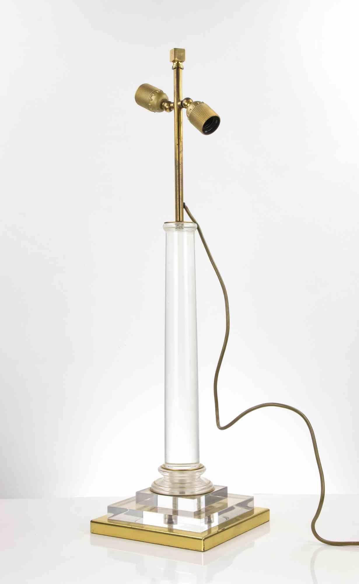This Italian Table Lamp is an design lamp manufactured in Italy by Corinne Halna. 

Brass and plexiglass table lamp.

Lampshade not included.
Two untested electrified lighting points. 

Good conditions, except for a brass edge slightly