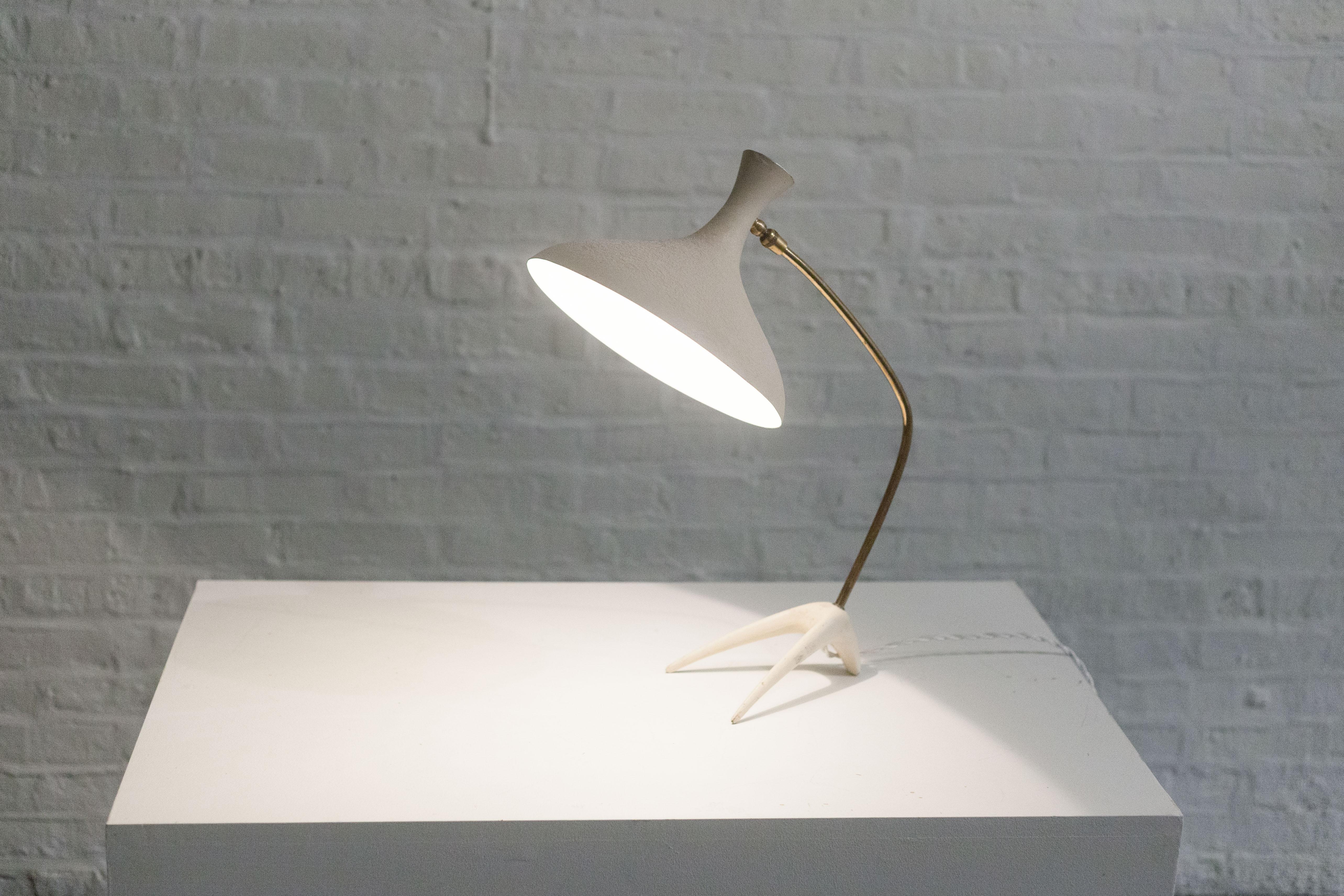 Imported from Germany, a mid-century 1950s lamp long attributed to Louis Kalff and now known to be Cosack Leuchten. 

The white metal shade with its biomorphic, organic form has an angelic trumpet like shape and its original crepe textured paint.