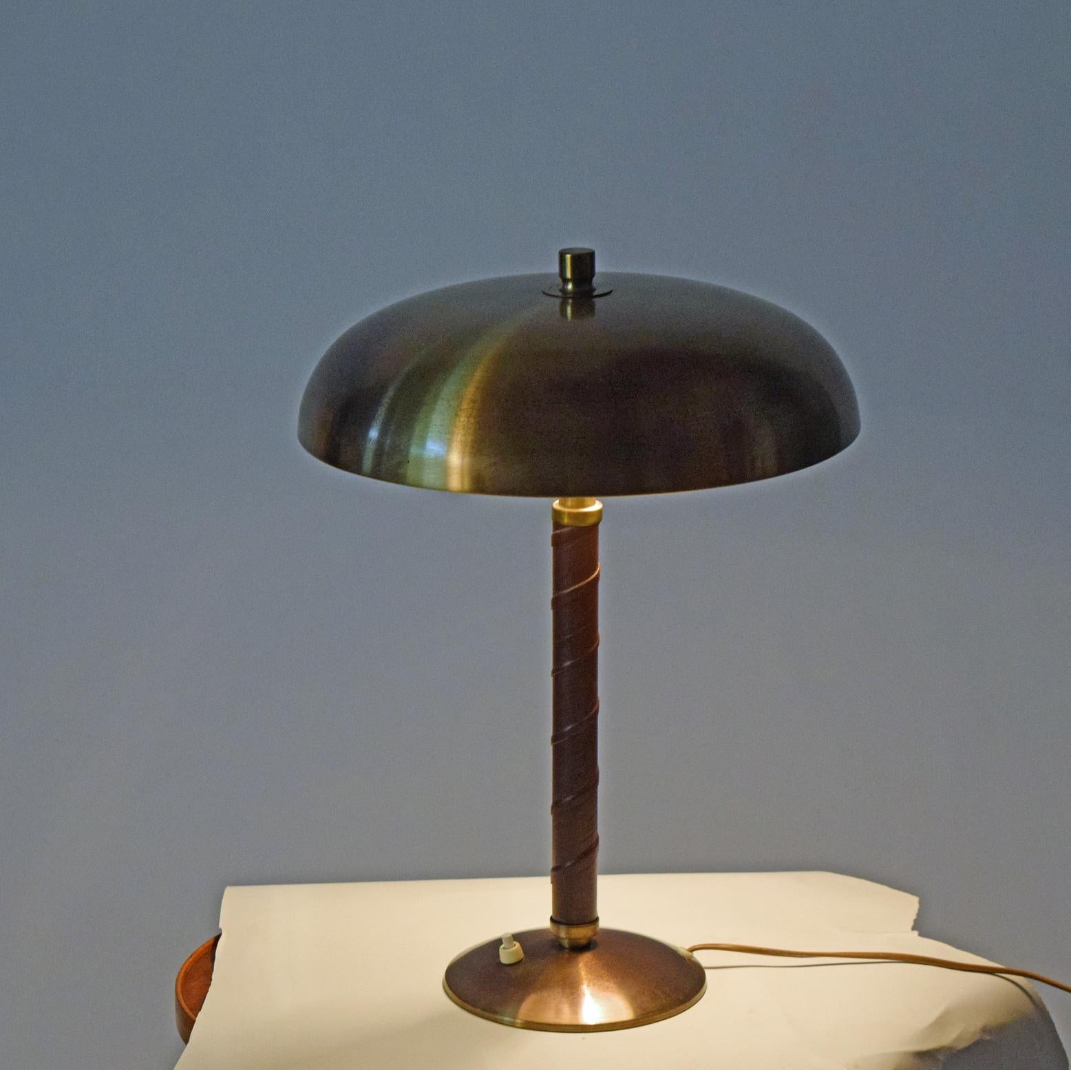 Swedish table lamp by Einar Båckström circa 1940s dome brass top with a leather wrapped stem Stamped on the base.