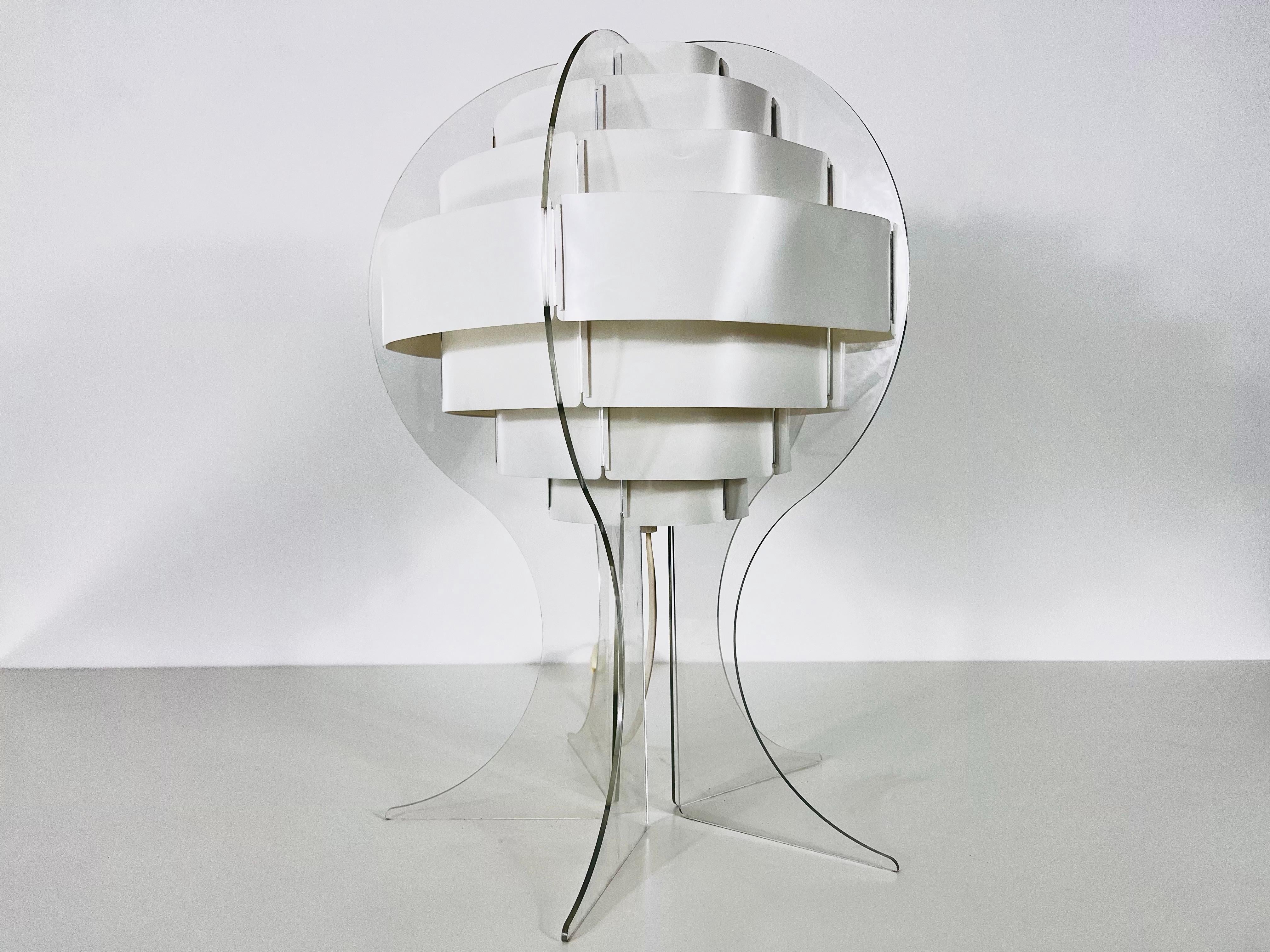 This sleek and futuristic table lamp is a classic representation of the Space Age design aesthetic. Designed by Flemming Brylle & Preben Jacobsen in Denmark during the 1960s, this lamp embodies the era’s fascination with space exploration and