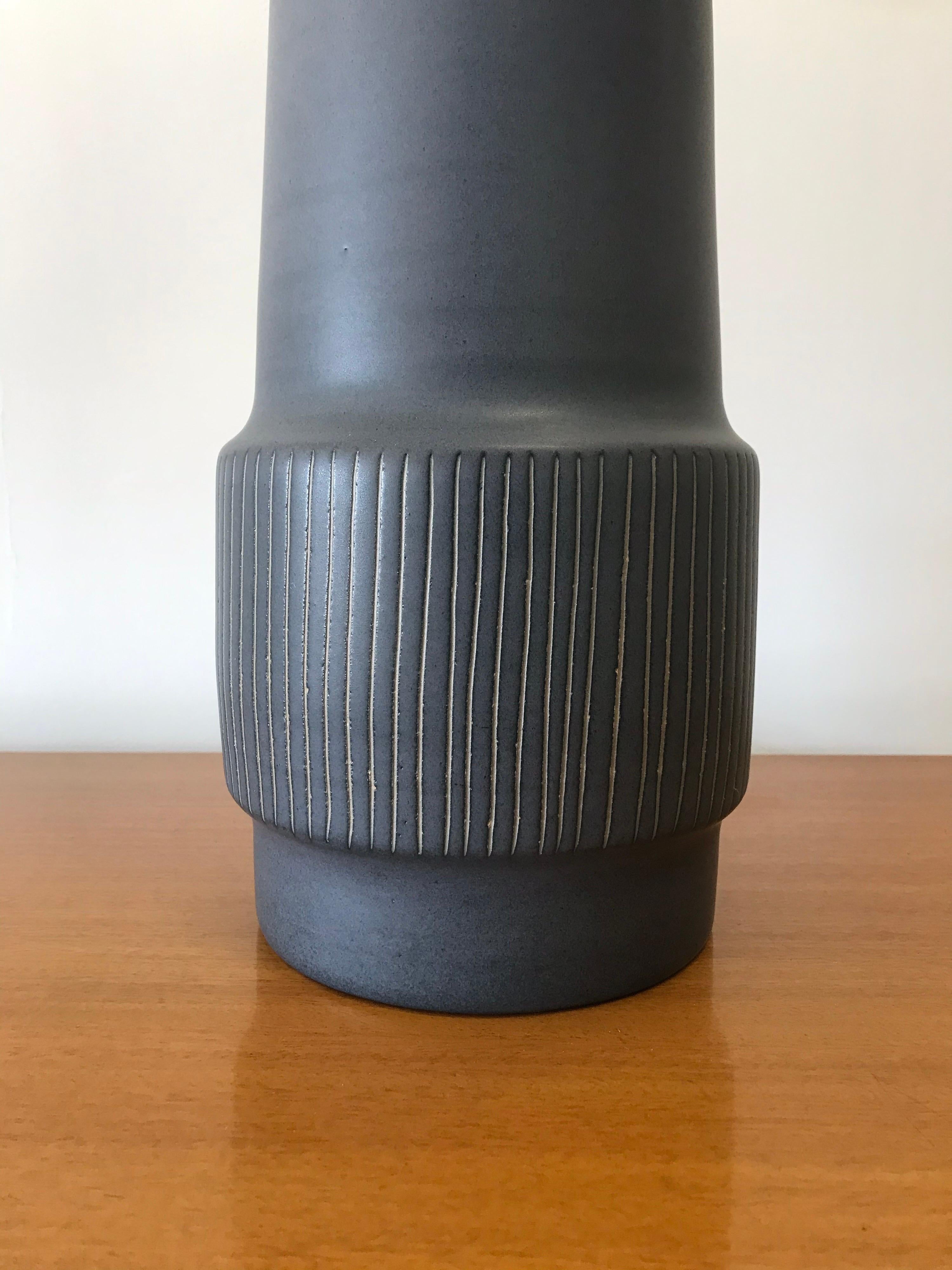 Large ceramic lamp by famed ceramicist duo Jane and Gordon Martz. Flat blue glaze with incised detail. New harp and new shade

Meausres: Overall
28.5” tall
15” wide 

Ceramic portion
15.5” ceramic 
6.75” wide ceramic.