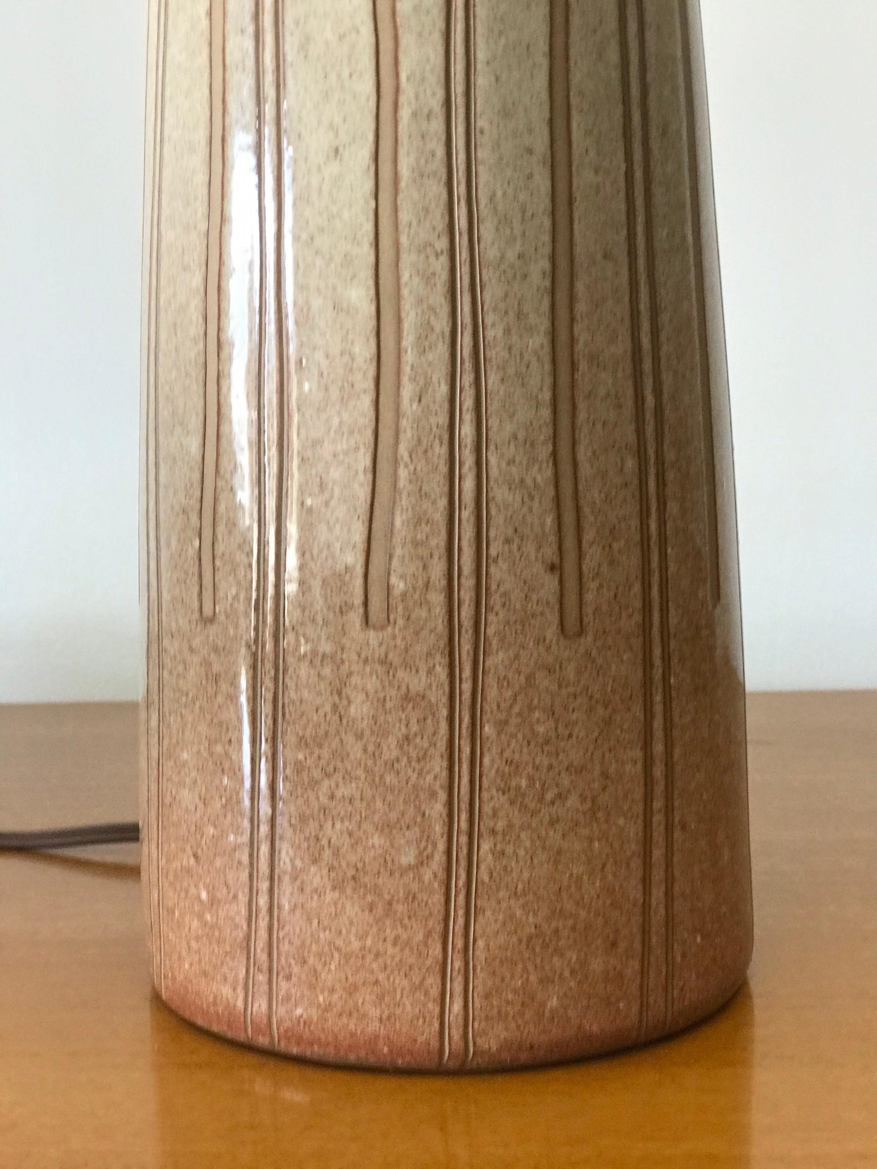 Table lamp by ceramicist duo Jane and Gordon Martz for Marshall Studios. Blush rose colored with incised spiral detail. 

Measures: Overall 
25” tall 
15” wide 

Ceramic portion 
11” tall 
5
