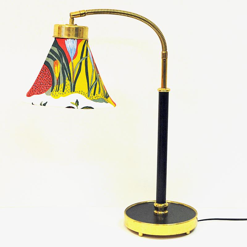 Wonderful table lamp with typical flower patterned lamp shade fabric designed by Josef Frank for Svenskt Tenn. This is model 2434-2 designed in 1939. Polished and lacquered brass. Measures: Total height about: 57 cm H in normal position about 90