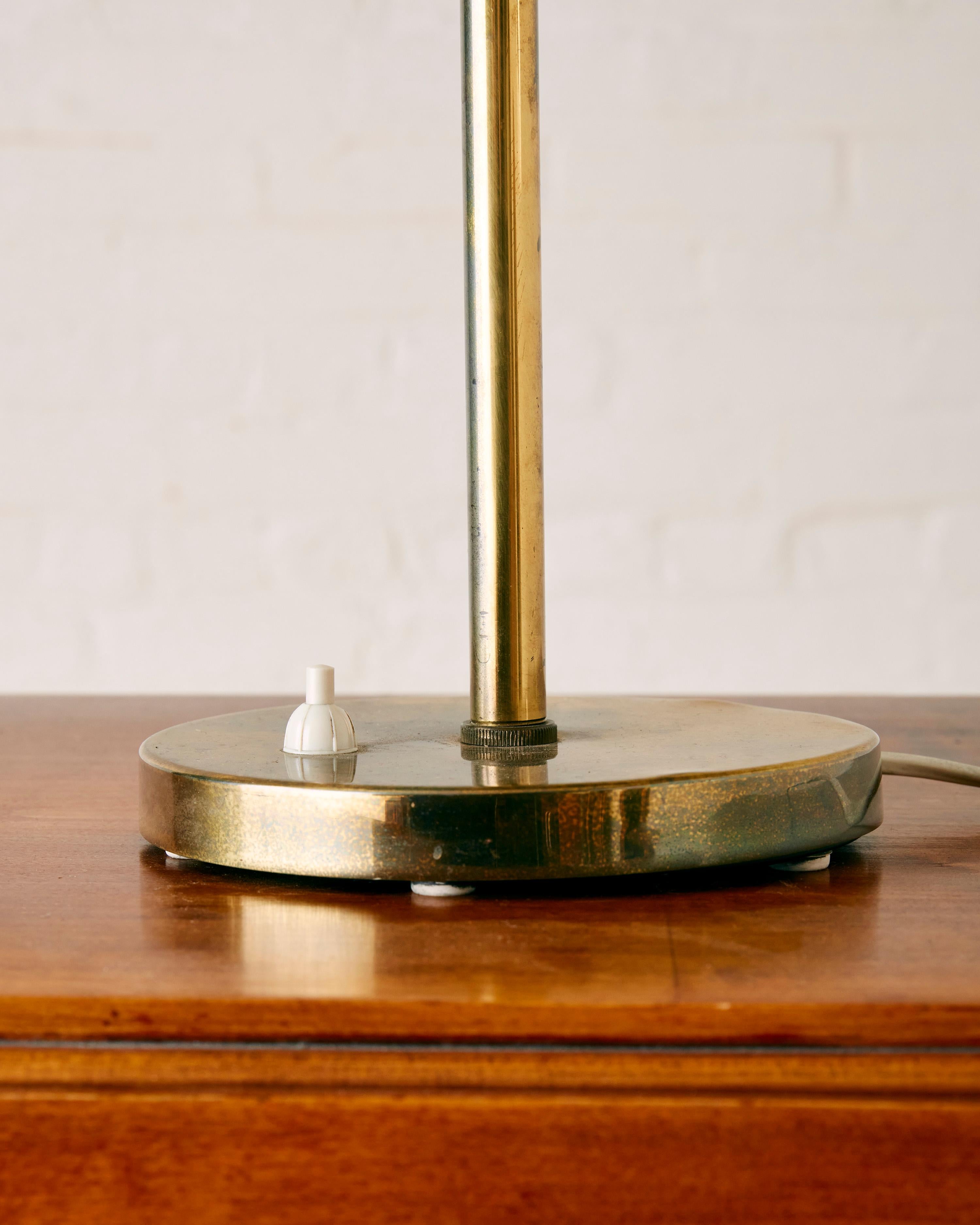 Table lamp, designed by Kai Ruokenen for Lynx Finland, incorporates two brass plates as shades, providing the option for multiple sources of illumination.

Dimensions: 56.5