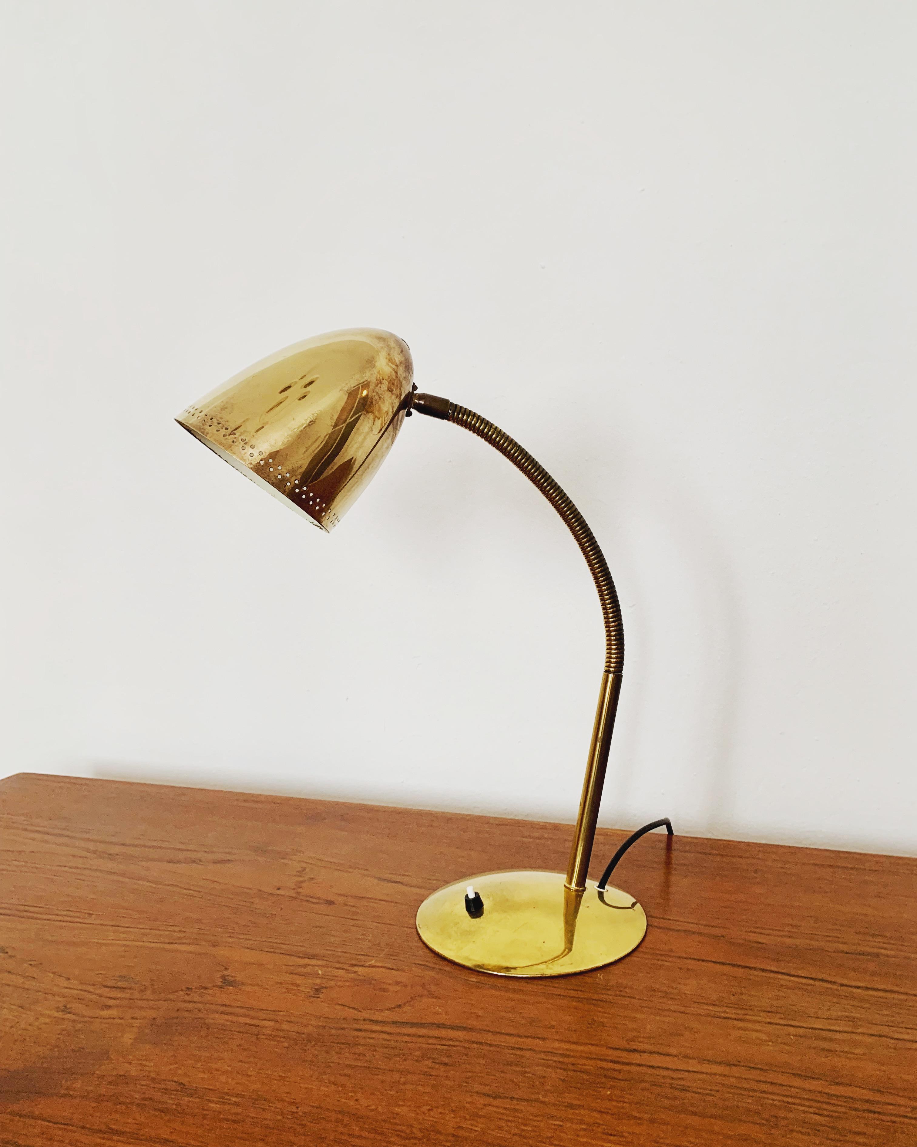 Extremely great and large table lamp from the 1950s by Kaiser Idell.
Fantastic mid-century design.
The combination of high-quality workmanship and loving details enriches every home.
The decorative holes in the lampshade create a beautiful play of