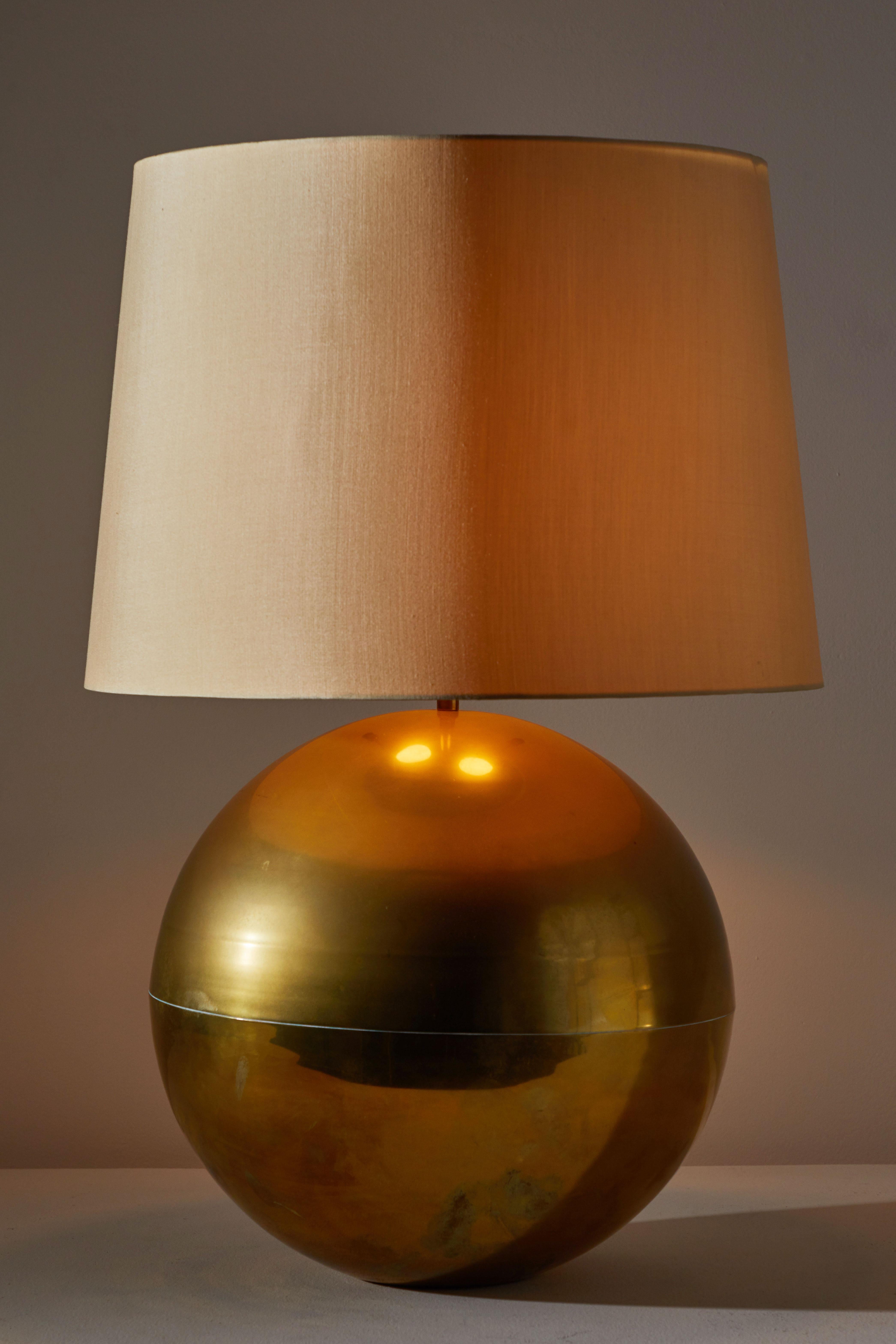 Table lamp by Karl Springer. Designed and manufactured in the US circa 1980s. Brass with silk shade. Shade not included. Original cord. Takes one E26 75w maximum bulb. Height displayed is from base of light to of finial.