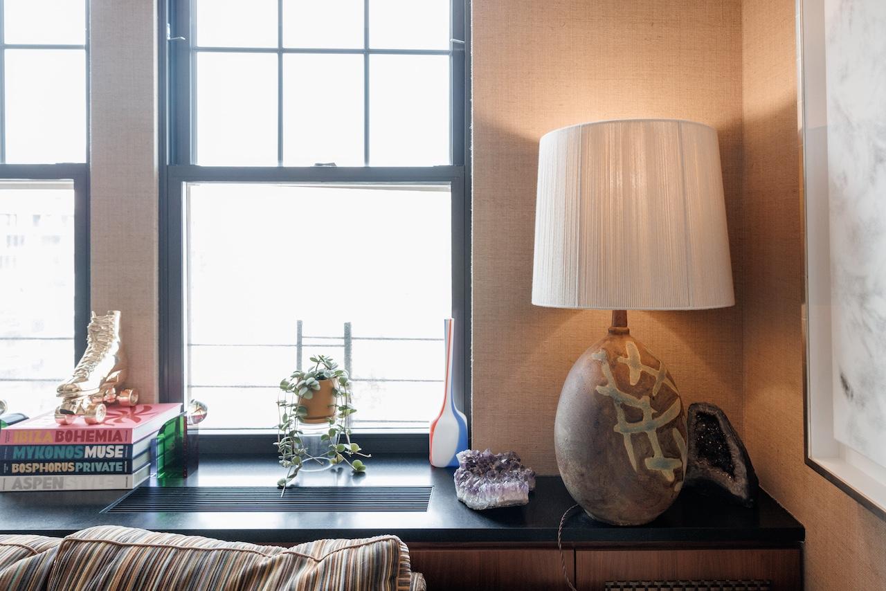 A ceramic table lamp with blue figurative etchings within a brown glaze that showcase a rich texture connecting an archaeological reference with a contemporary artisan's eye.

Andy Cohen is a longtime supporter of Housing Works and has generously