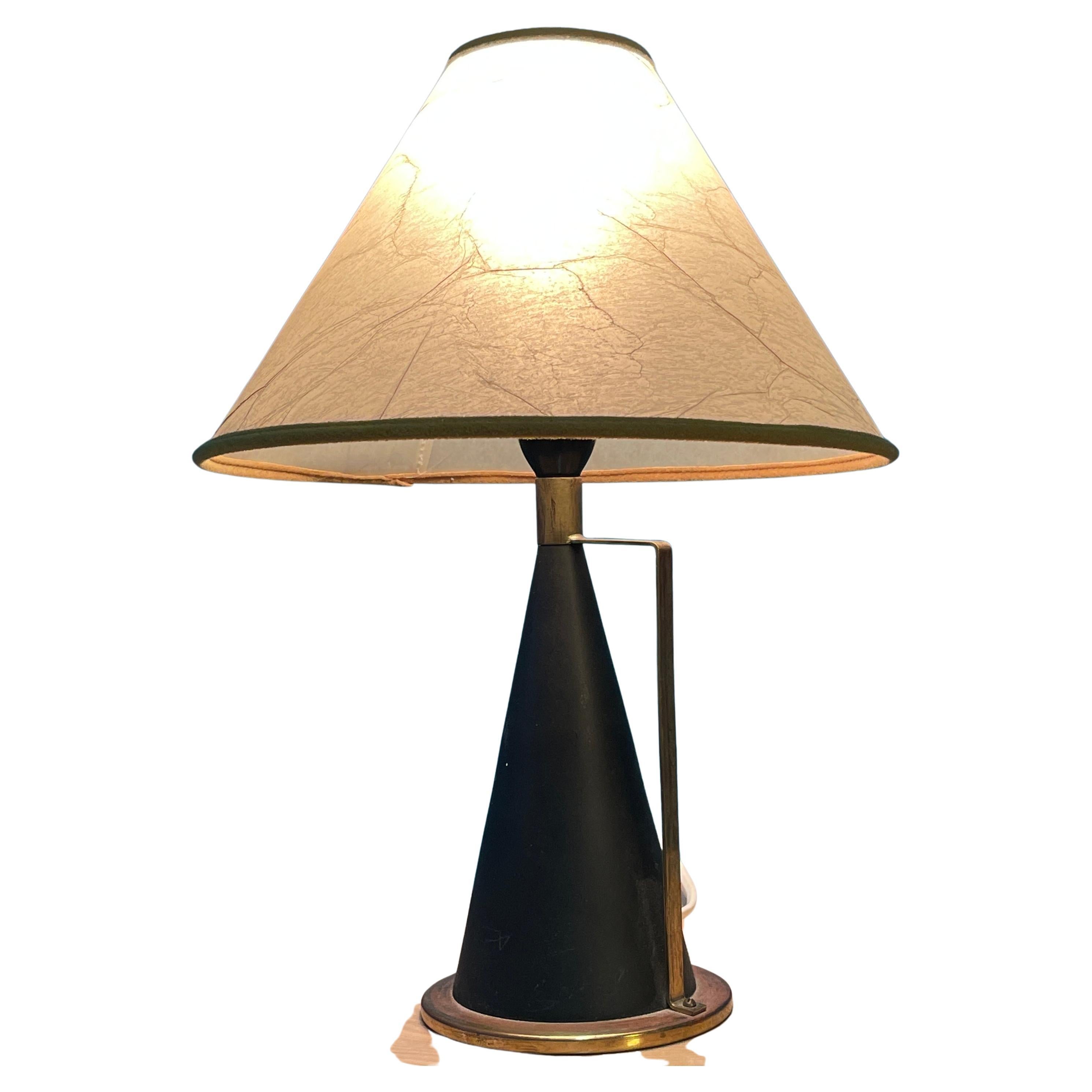 Simply and stylish table lamp with a brass handle. 
Designed by Maria Lindeman and manufactured by Idman Finland. 
Manufacturer's Stamp on the bottom.

The Cone-Shaped frame is black painted metal. Lower and Upper part of frame have Brass