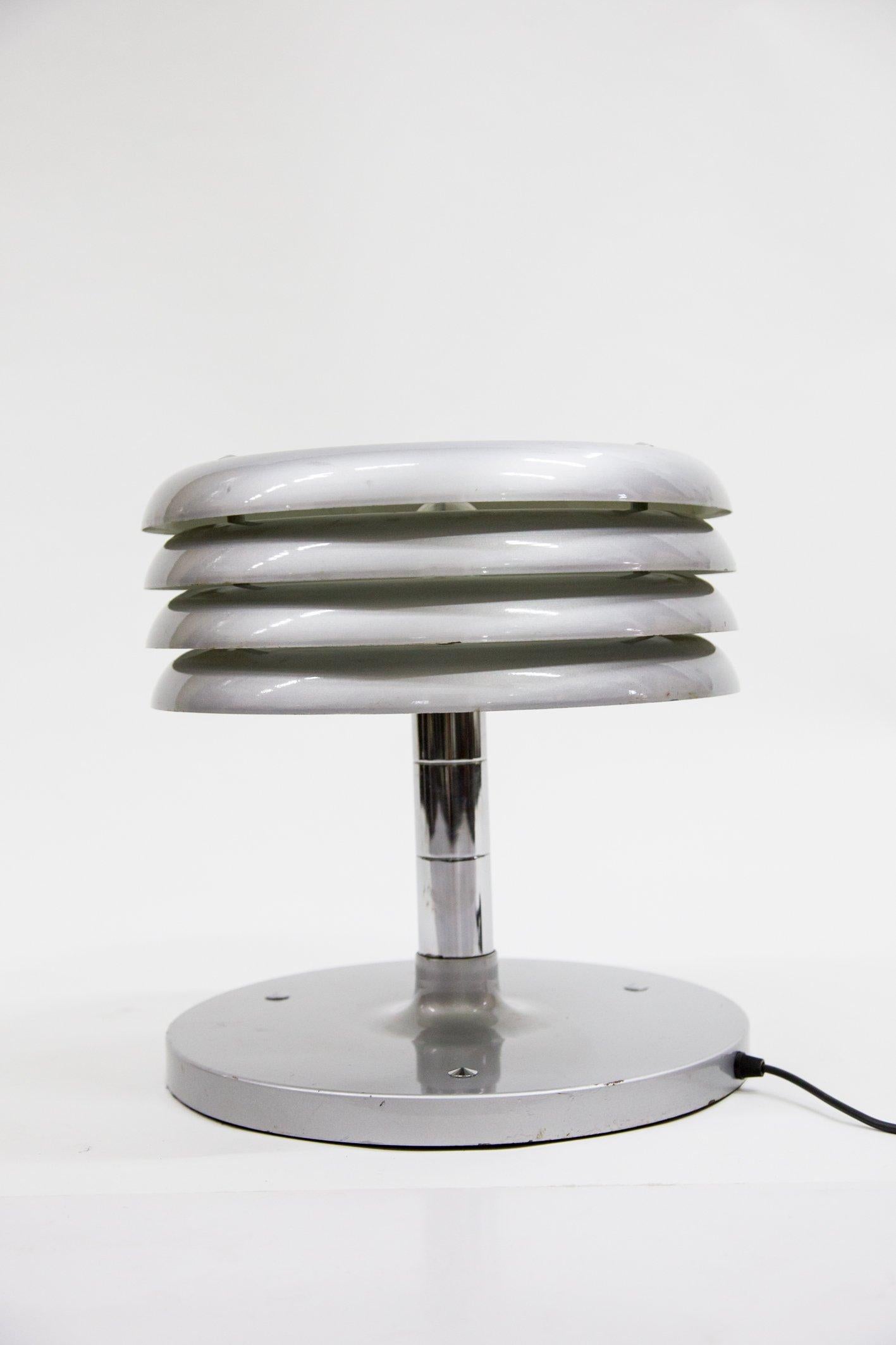 Designer piece by Tamas Borsfay, 1960s-1970s era. Manufactured in Hungary, these table lamps are getting more and more rare.
Painted and lacquered silver, with some slight scratching and damage on the paint. Electronically restored.

This piece has
