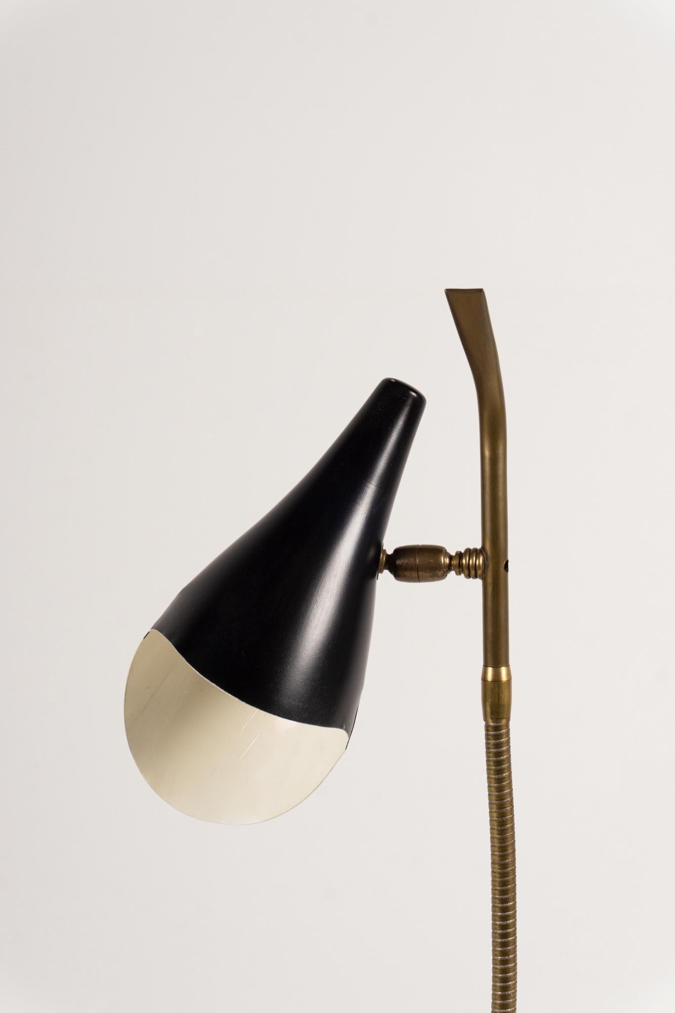 The Italian designer Oscar Torlasco created this beautiful, simple table lamp for Lumen in 1955.
The construction is made of brass and the base is made of marble.
The adjustable reflector is made of black lacquered aluminum.