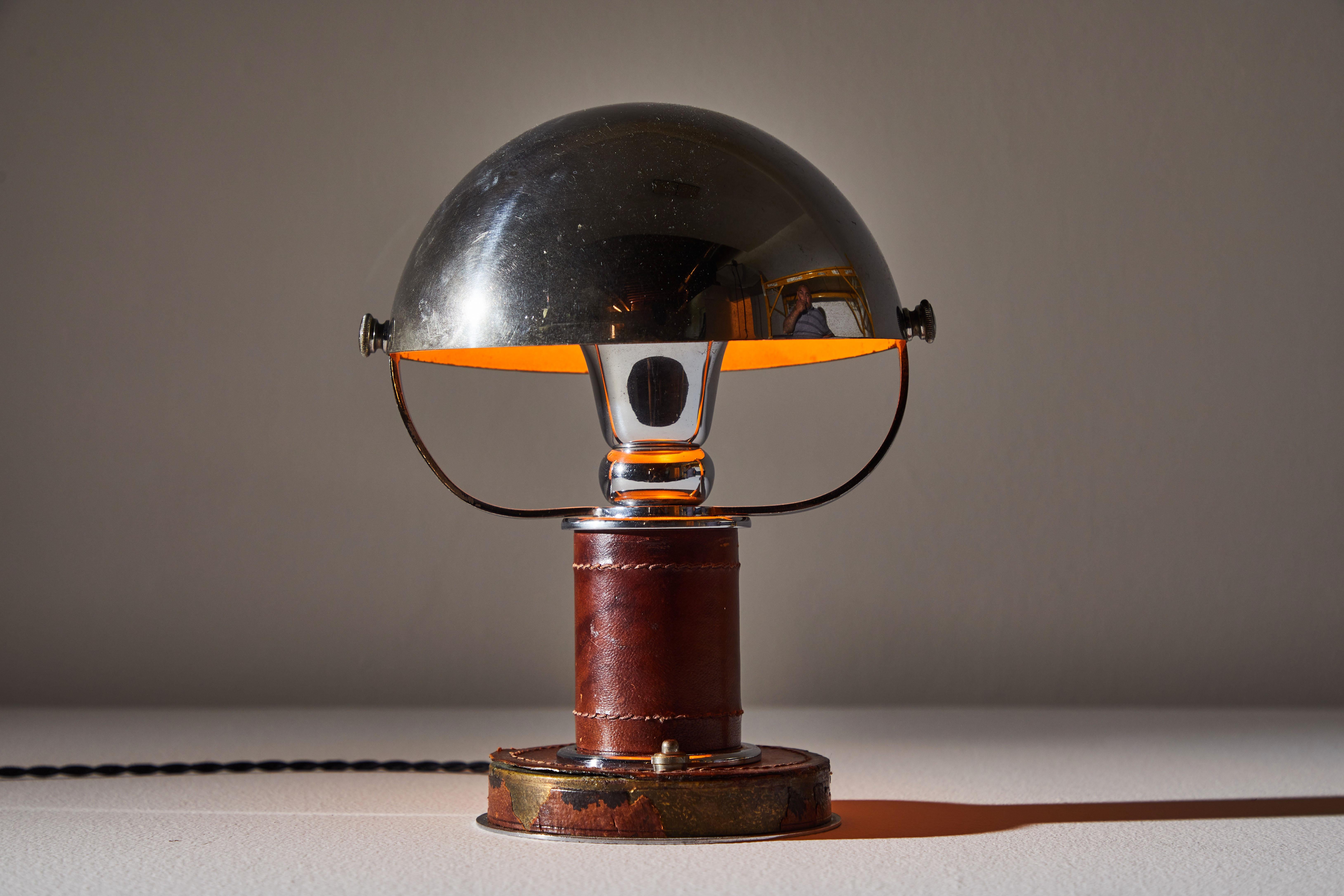 Table lamp by Paul Dupre for Hermès. Designed and manufactured in France, circa 1920s- early 1930s. Art Deco leather and chrome table lamp. Rewired with black french twist cord for U.S. standards. The rotating hemispherical shade is supported by two