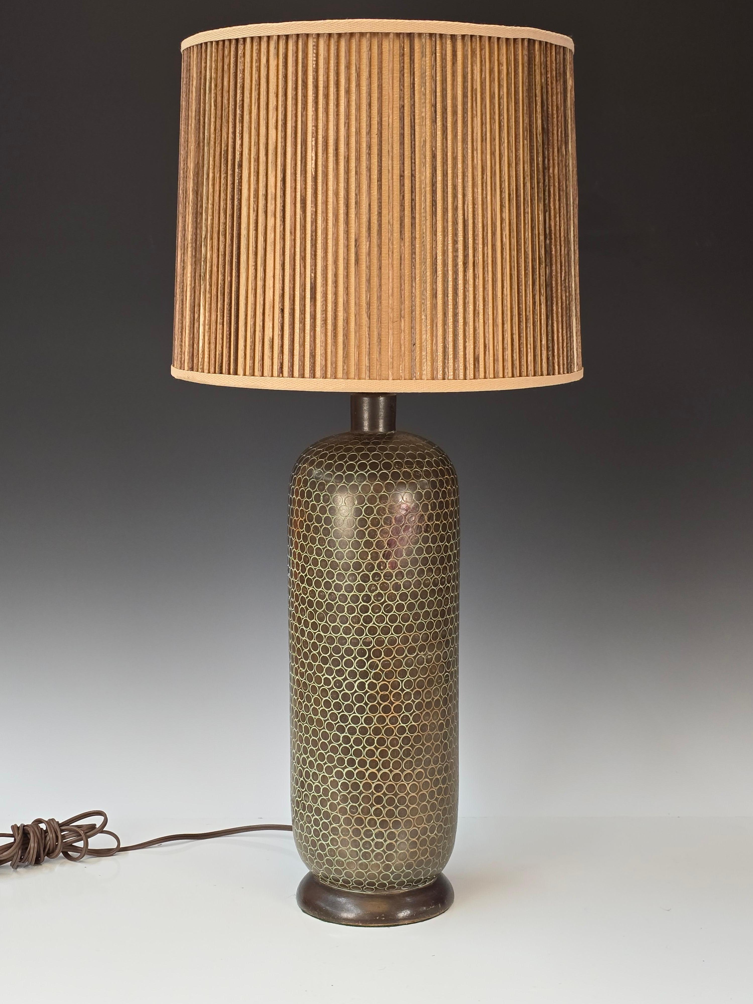 Stunning sgraffito lamp by Ugo Zaccagnini featuring a shade constructed of equally spaced dowels of walnut.   The lamp base is incised with circles and then a faux finish was rubbed into the pattern.   Sockets of lamp also have a paint treatment