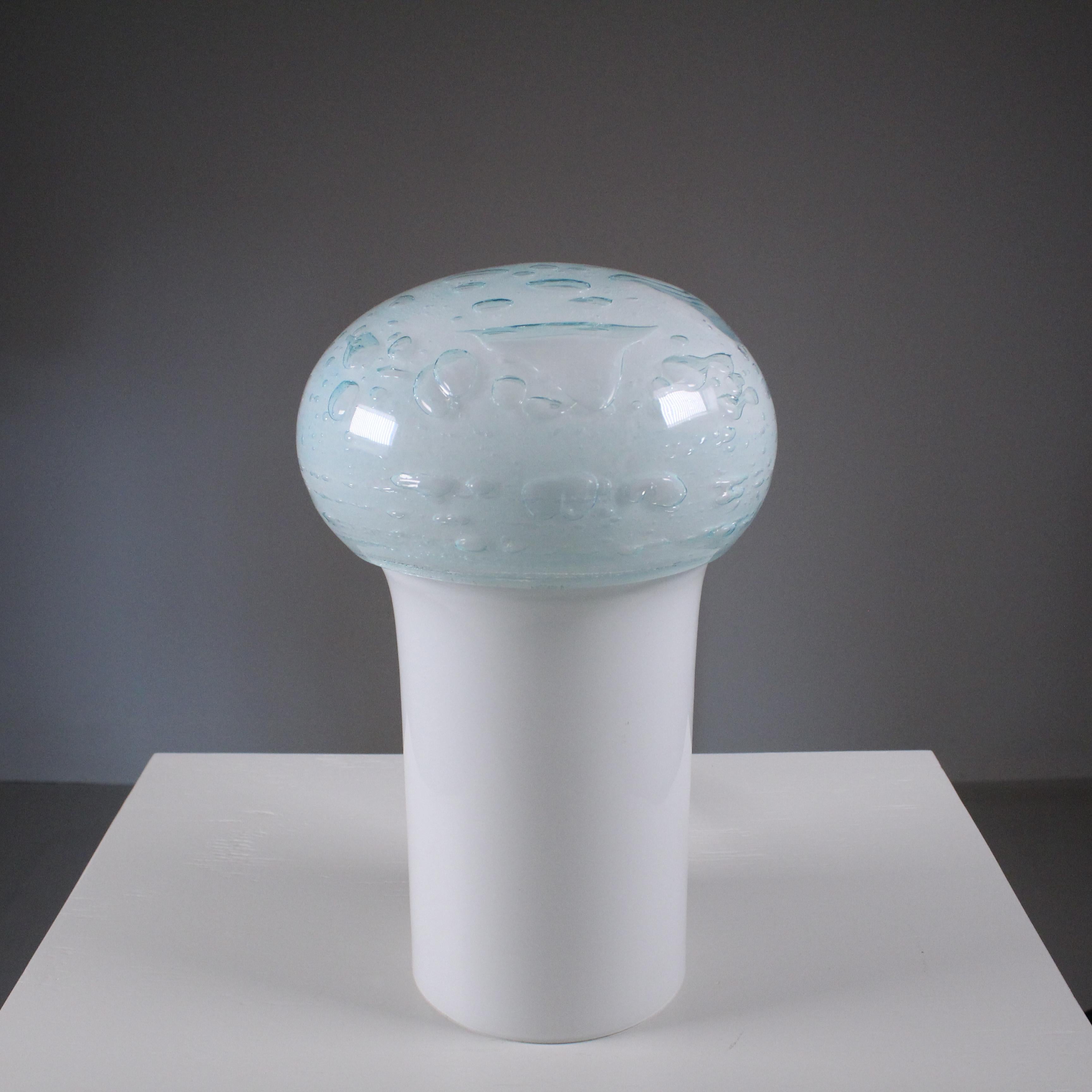 The mushroom-shaped table lamp by Vistosi, crafted in Murano bubble glass, is a captivating work that seamlessly combines artisanal mastery and contemporary design. This exceptional lighting piece captures the essence of Murano glass artistry and