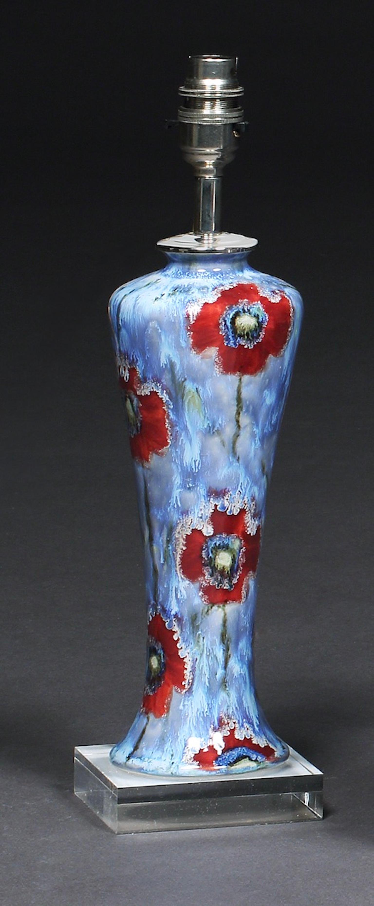 Cobridge, poppy and ice pattern, hand painted vase converted into a table lamp on a perspex base, 10½ “ high
One of Cobridge Pottery’s most popular patterns, designed by artist Anita Harris, leading designer at Cobridge, Moorcroft & her own studio