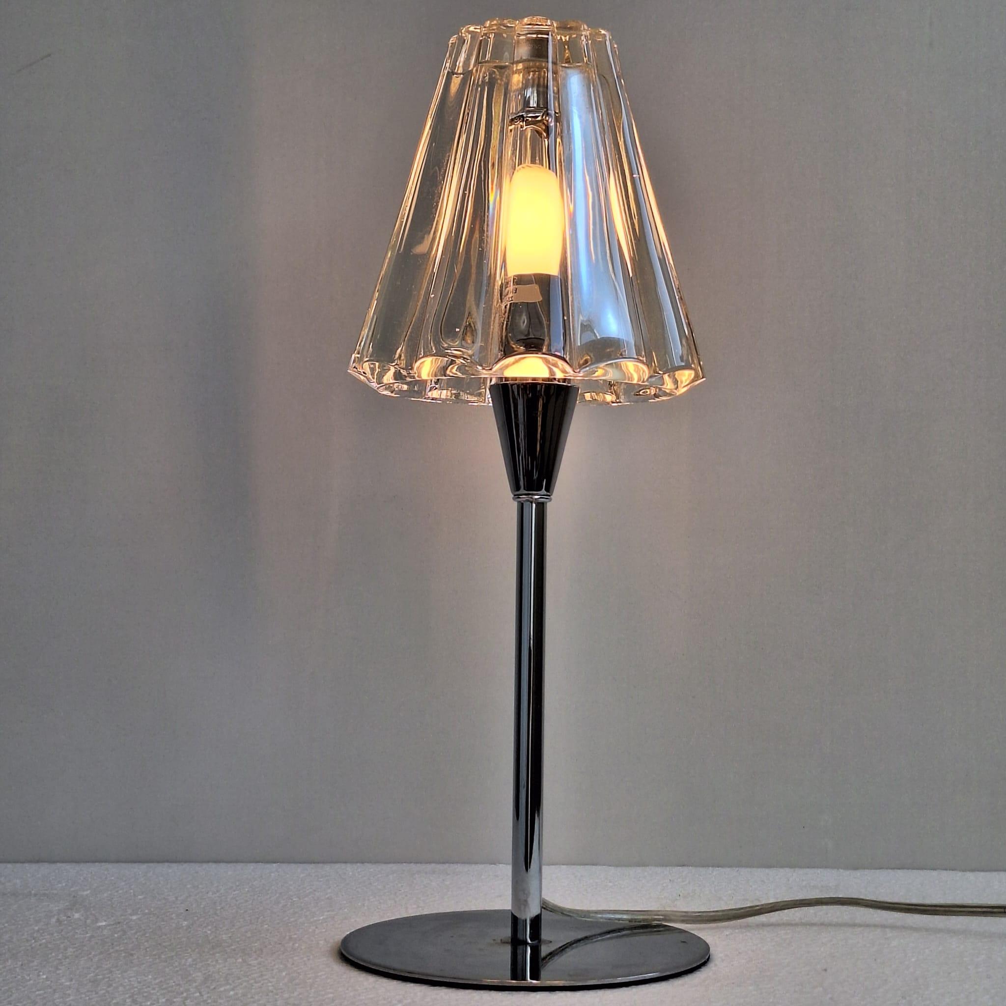 A contemporary design table lamp designed by Cristian Cubiña for Spanish brand Alma Light. The lamp is made of chromed metal with a high-quality fluted glass shade. The lamp emits a warm light and features a dimmer.

Absolutely no chips or cracks.