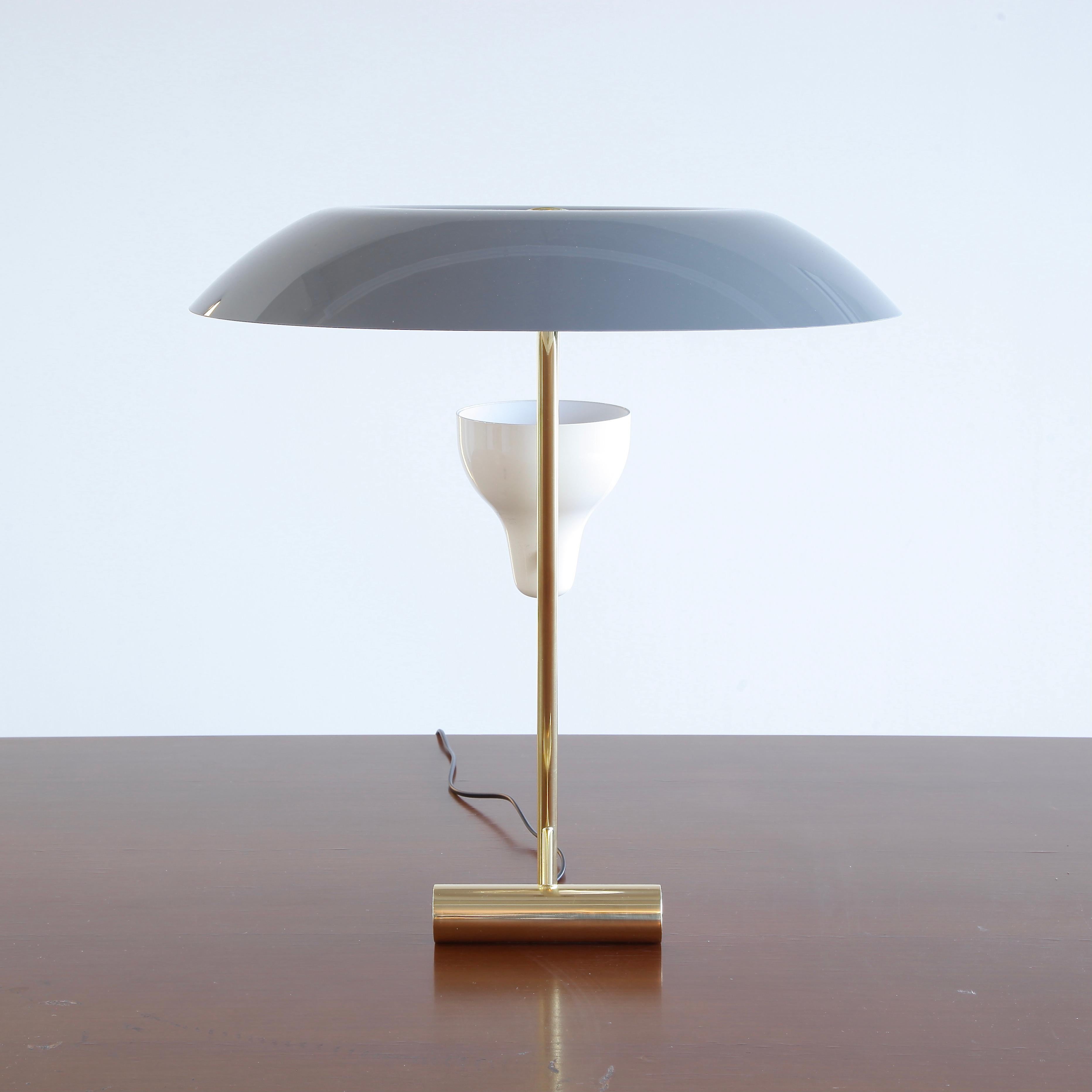 Table lamp, designed by Gino Sarfatti in 1951. Re-edition, 2020.

The re-edition lamp (Model 548) with polished brass stem, grey reflector and adjustable uplighter. LED lighting with integrated dimmer.

Literature: GINO SARFATTI by M. Romanelli