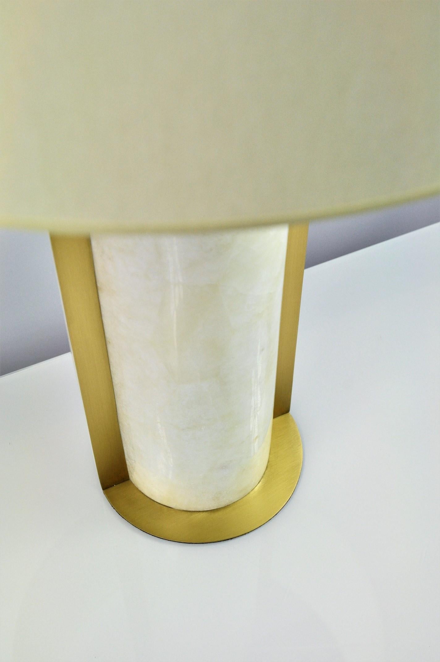 The table lamp ECLIPSE by Ginger Brown is made of rock crystal and brushed brass trims.
The style is timeless with a modern touch thanks to its cylindrical shape. A must have on a large console table or a dresser. 

This lamp can be delivered with