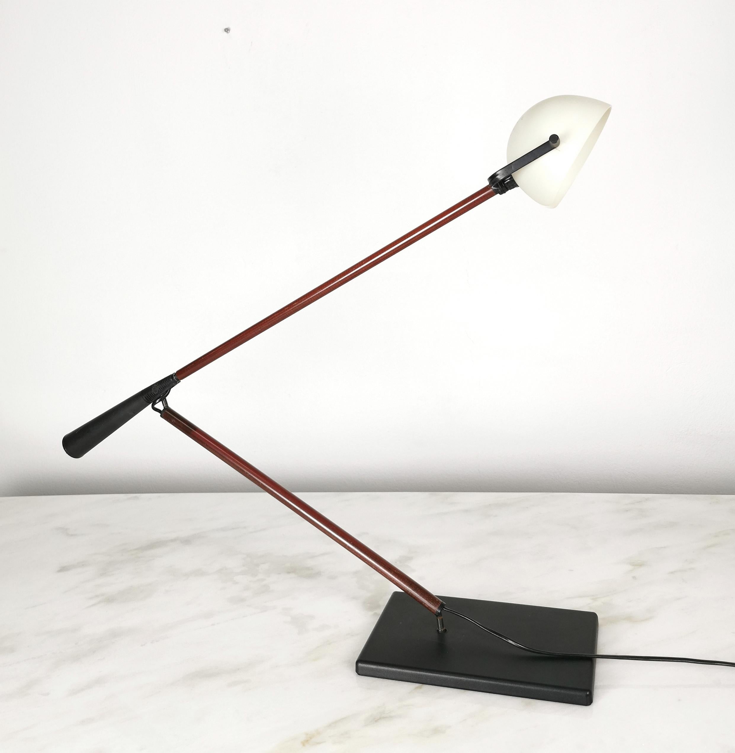 Rare model 613 table or desk lamp designed by Italian designers Paolo Rizzatto and Gino Sarfatti and produced in the 1970s by Arteluce.
The lamp was made of fiberglass with a black rectangular base, support and arm in red with a counterweight at