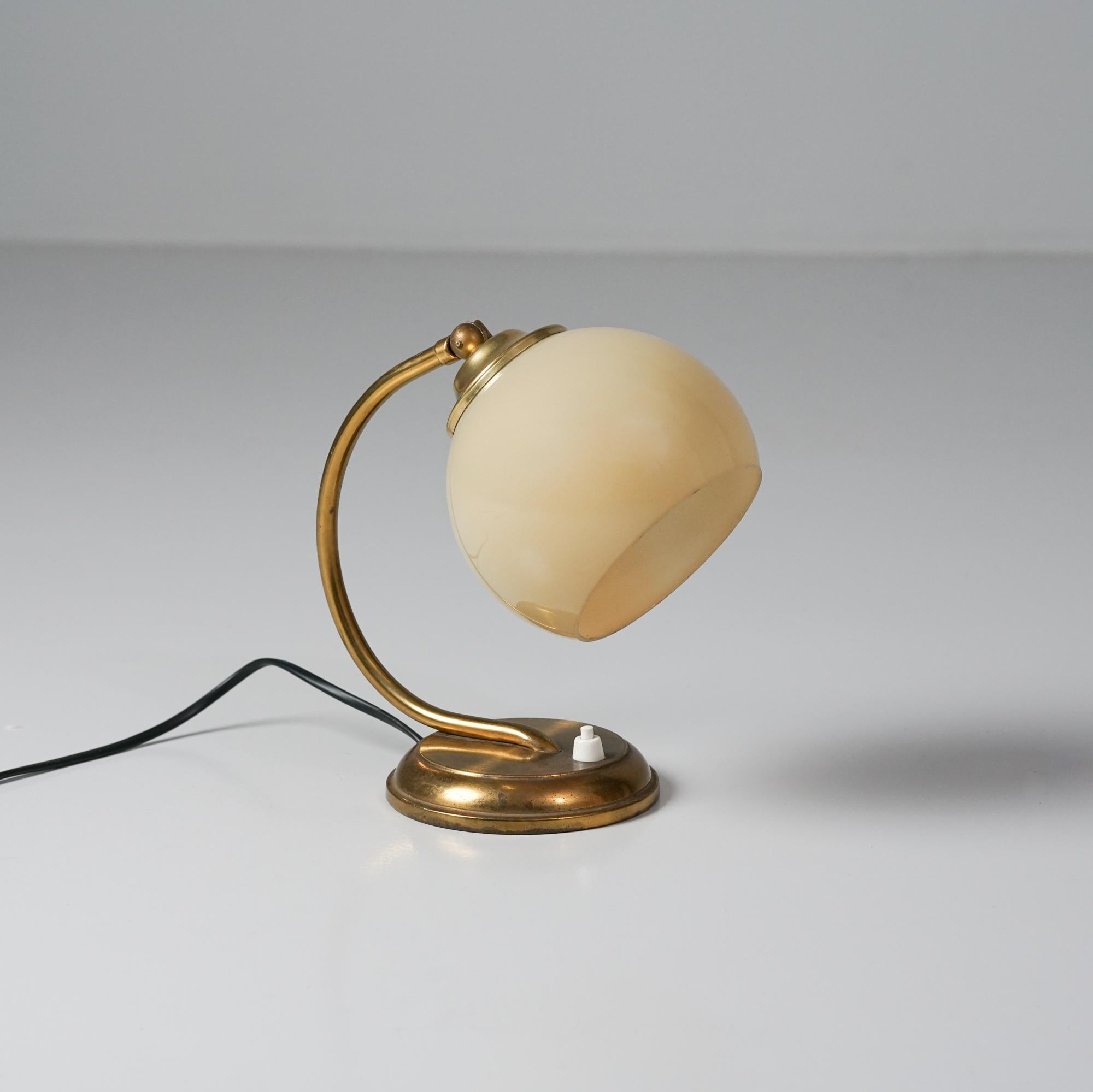 Lampe de table, fabriquée en Finlande, années 1940/1950. Laiton et verre opalin. Bon état vintage, patine mineure correspondant à l'âge et à l'utilisation. 