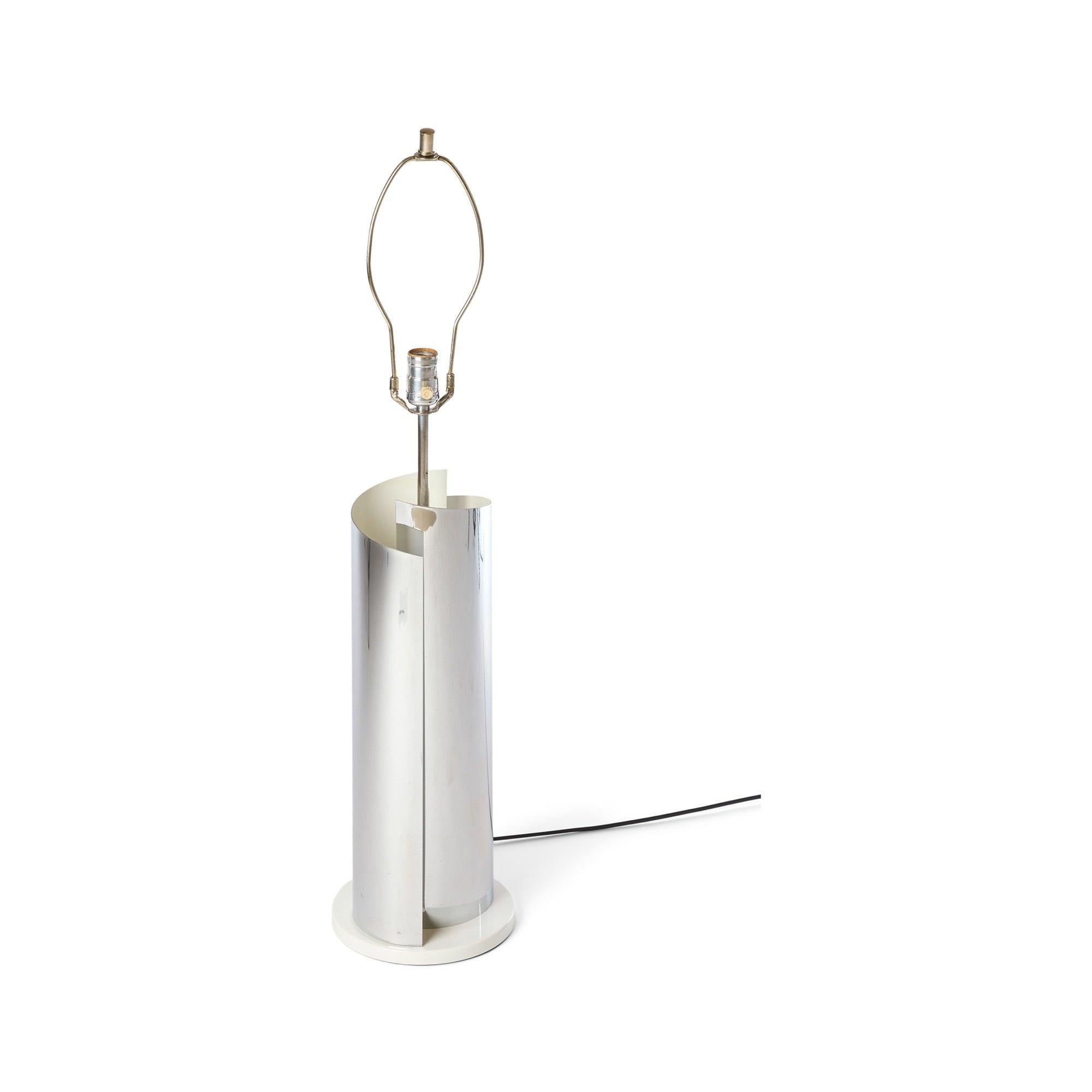 A table lamp in a rolled steel mirrored finish.