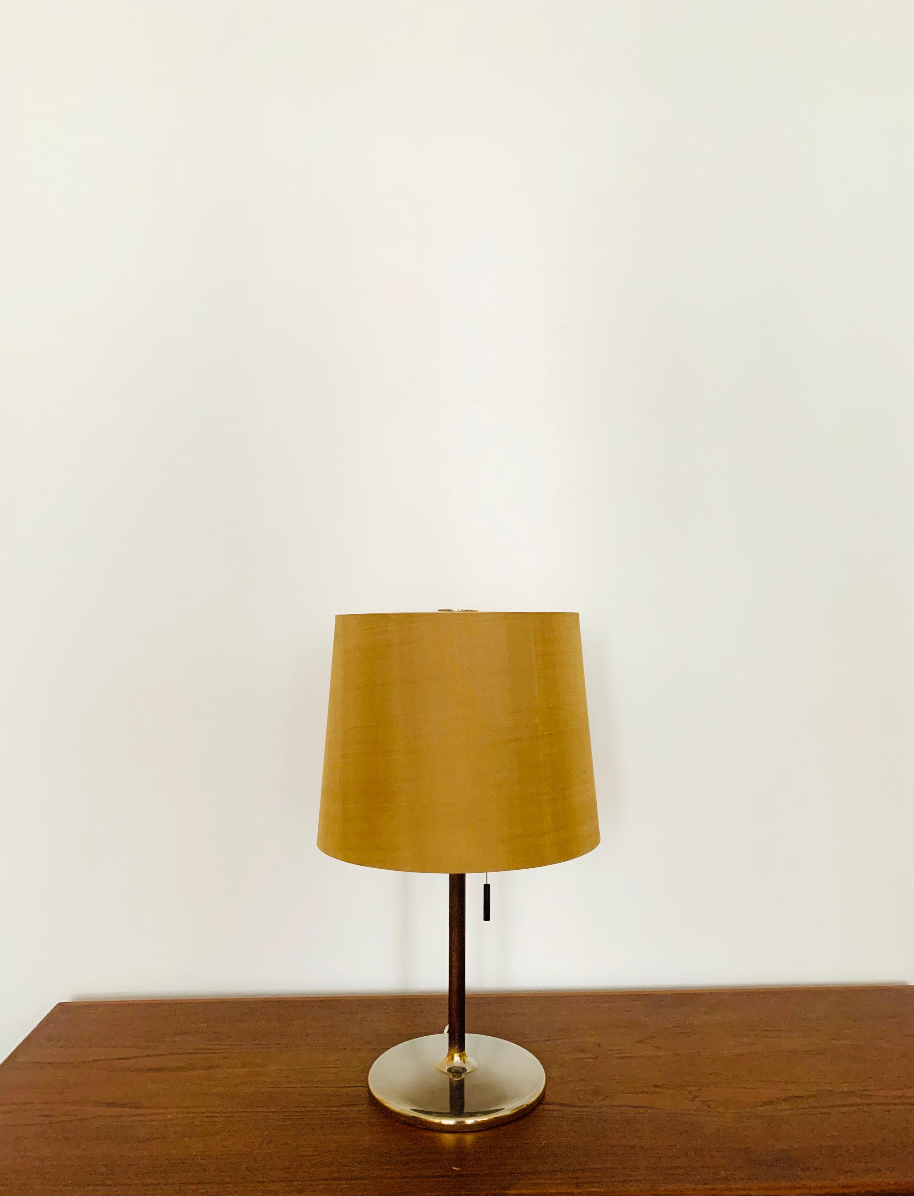 Beautiful and very elegant table lamp from the 1960s.
High-quality design with a fantastically elegant appearance.
Very solid processing.
The natural silk lampshade is very special.
A spectacular play of light is created.


Condition:

Very