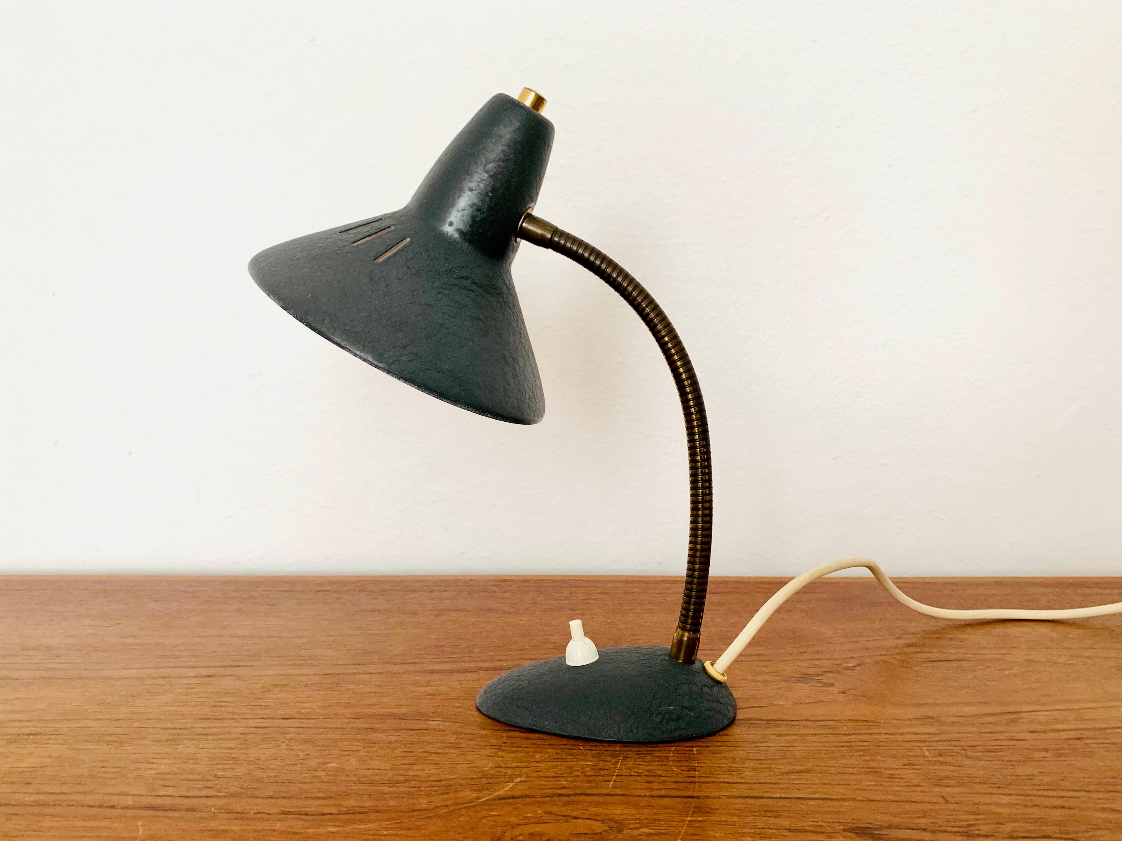 Very nice table lamp from the 1950s.
Wonderful timeless design with lovely details.
The lampshade can be flexibly adjusted.
It creates a very warm light and a great play of light.

Condition:

Very good vintage condition with slight signs of wear