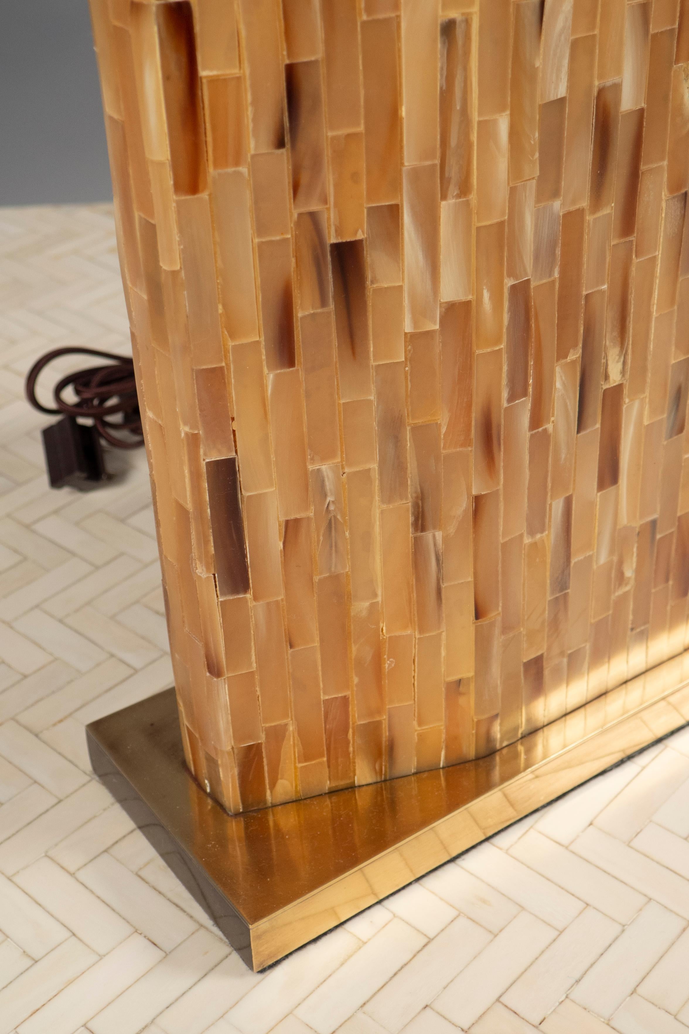 Elongated hexagonal body completely covered in beige bone tile, raised on a rectangular brass base.
 
(Lamp shade not included)