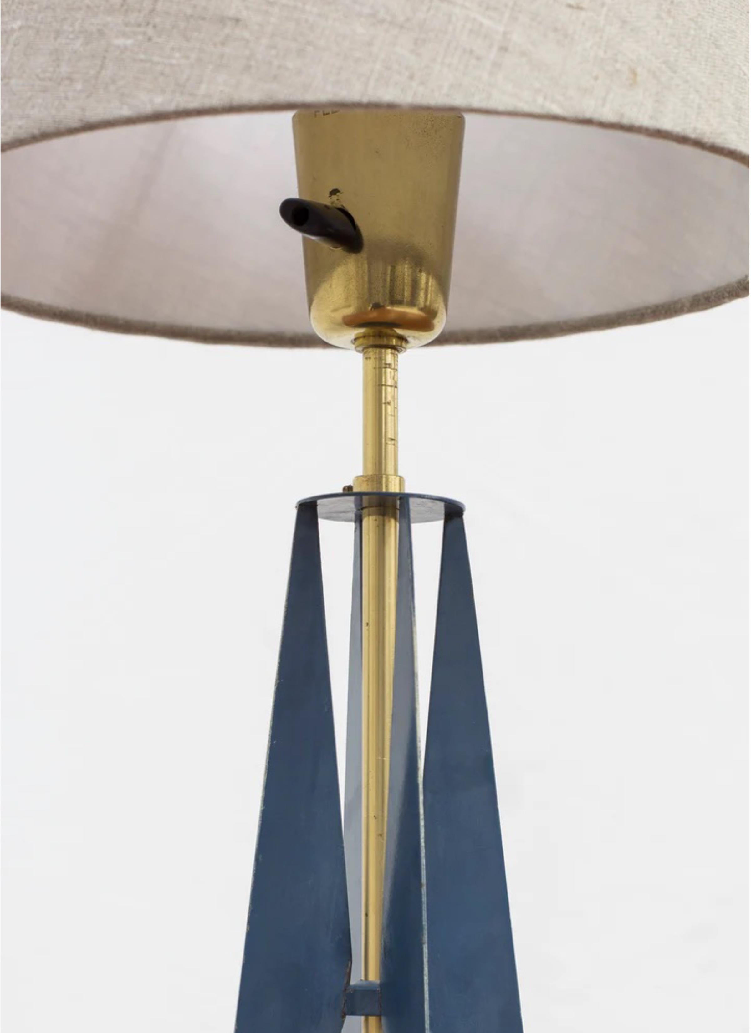 Table lamp produced in Sweden by Falkenbergs Belysning. Made sometime during the 1950s. Made from polished brass and metal with original blue paint. Original bakelite turn light switch in working order. New lamp shade in grey linen fabric. Good