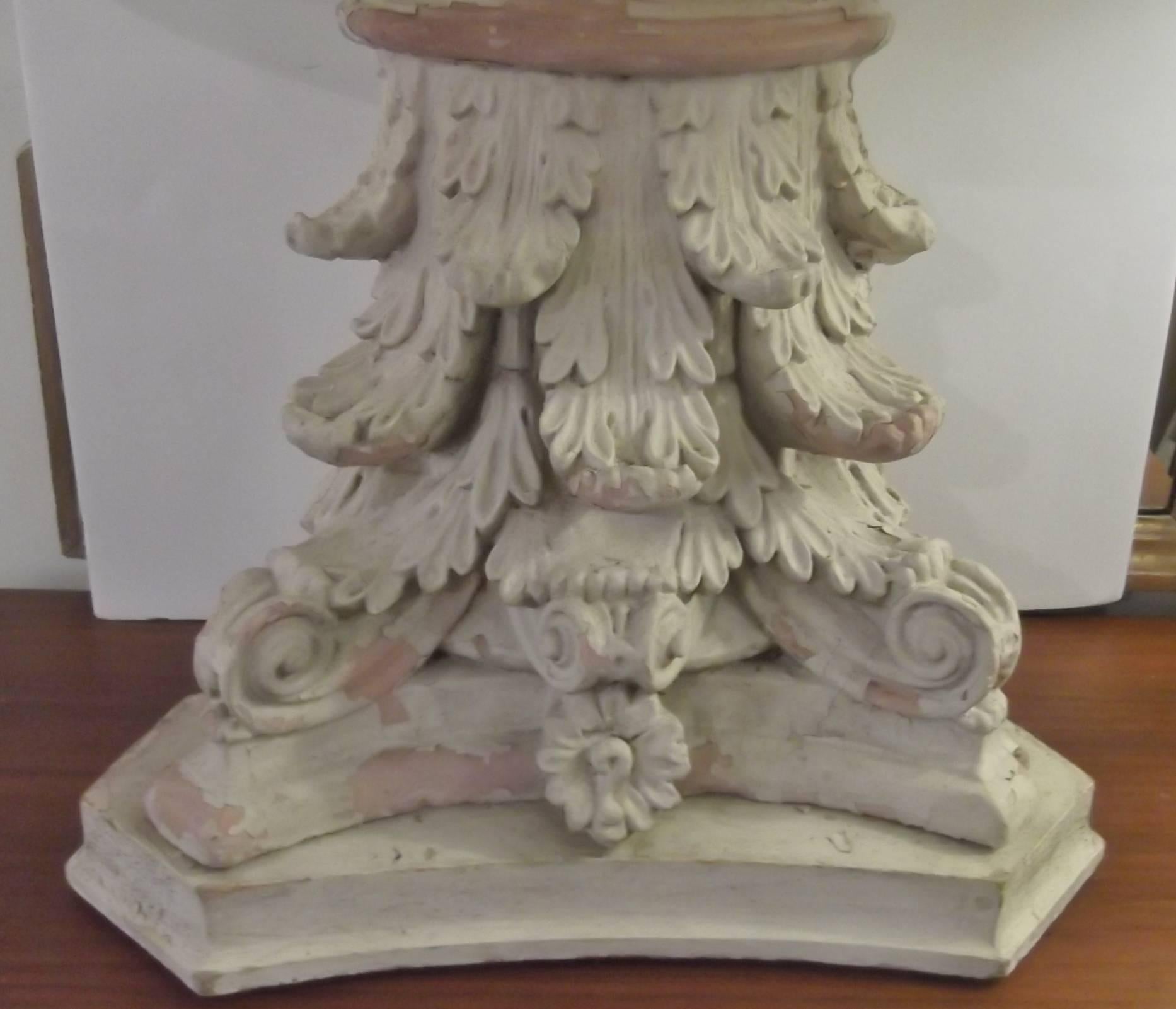 Unusual table lamp made from an architectural remnant from a NYC building. The painted terracotta capitol top is mounted on a wood base and wired as a lamp. The neoclassical capitol was once used to decorate a 19th century building from one of the