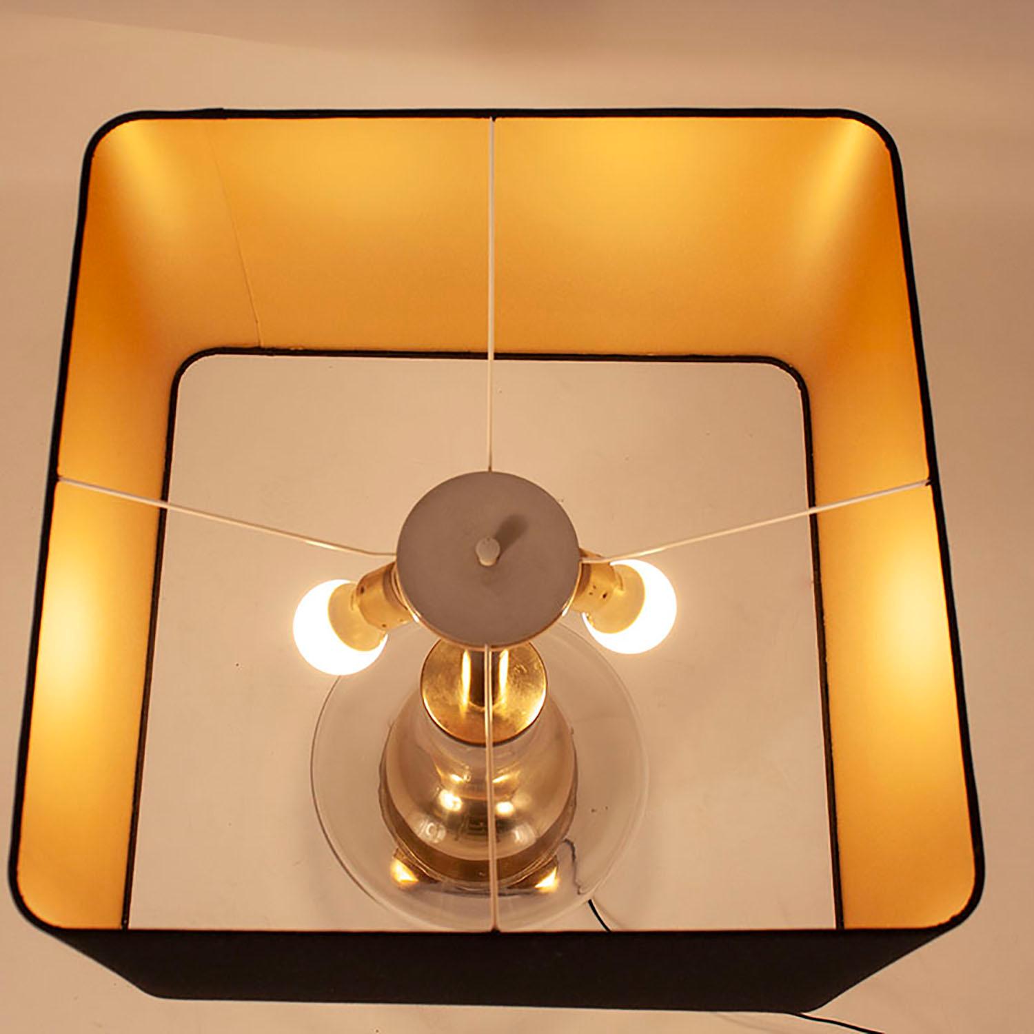 Table lamp designed by Lumica, 1970s. Gold brass and glass, midcentury.
Square shade with new fabric. Color black.
European plug (up to 250V). I have had a professional electrician re-wire the piece.
   
