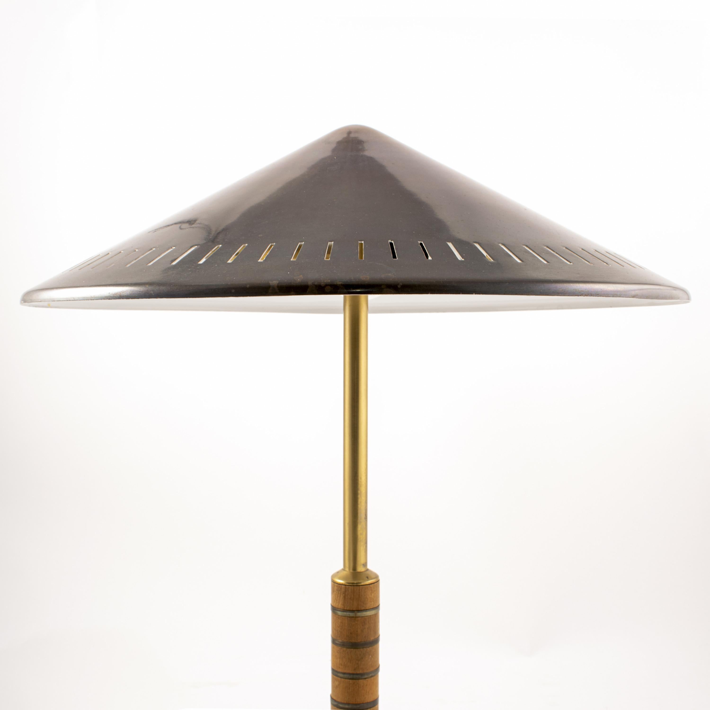 Danish brass table lamp from Lyfa 1956 designed by Bent Karlby. Model B146.
Solid brass with two-light sources, stem decorated with teak banding.

Untouched condition, can be polished shiny if desired.