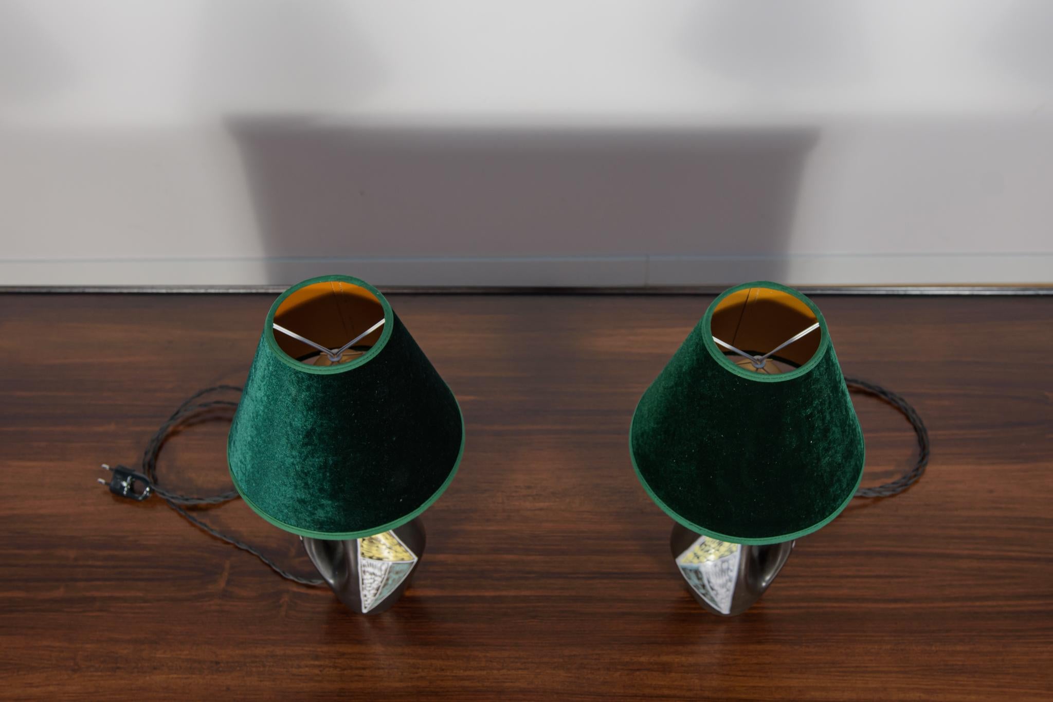 A pair of ceramic table lamps designed by Holm Sorensen for the Danish company Soholm in the 1950s. The wiring has been replaced. The lamps have new lampshades. The lamps are in very good condition, with slight signs of use. Checked by a