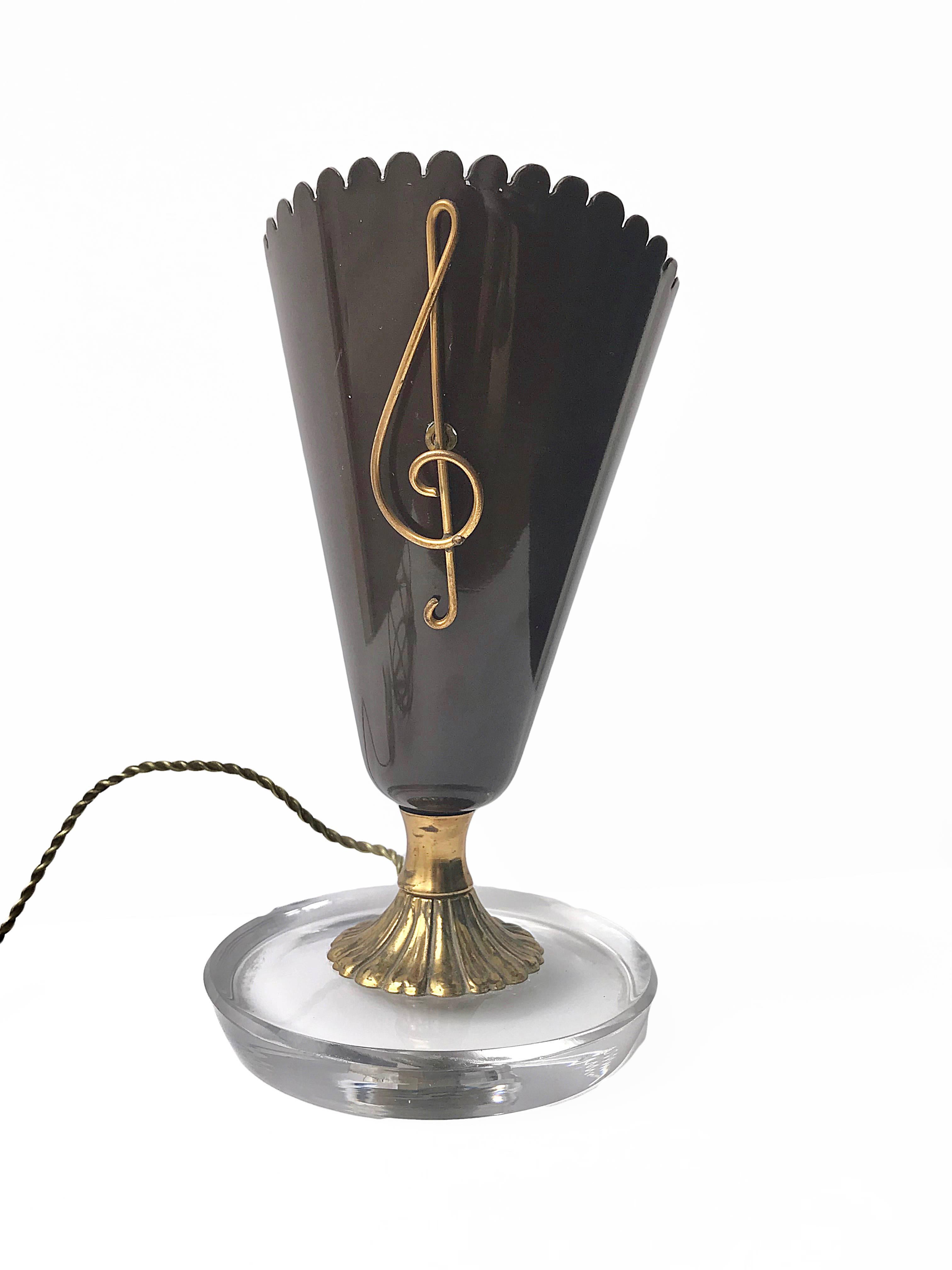 Beautiful table lamp with glass and brass base. Dark brown color. Musical note in brass. Gio Ponti style of the 1950s.