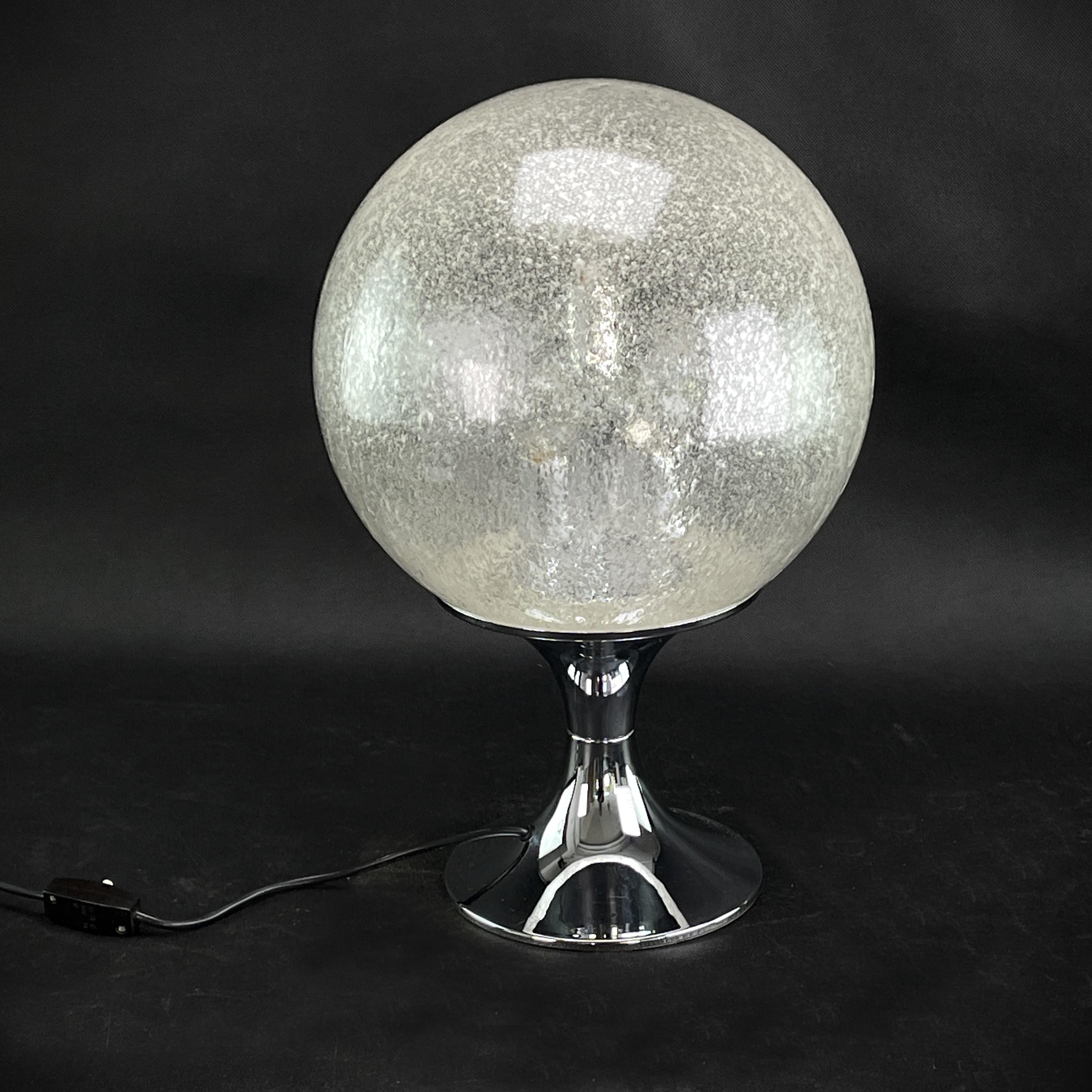 table lamp with big glass ball

The beautiful and rare lamp is a true design classic from the 60s. This lamp in the extraordinary design is a highlight for any lounge interior of the Panton-Eames era. This vintage lamp is an original and gives a