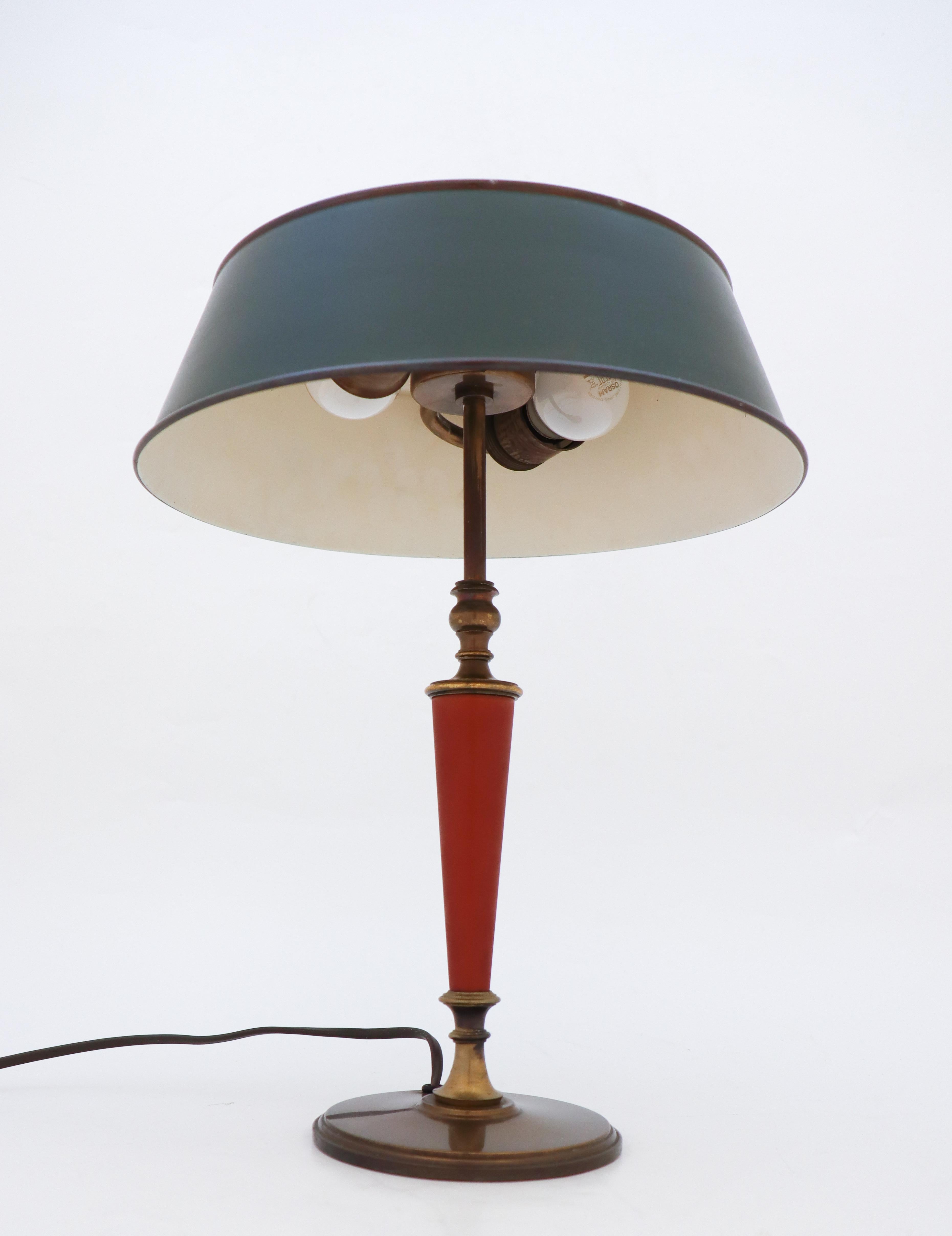 A lamp with a lampshade of green sheet metal and a base in cast iron produced by Böhlmarks lampfactory in the 1930s. The lamp is stamped with model number below. It is 43 cm high and in very good condition except from some minor scratches at the