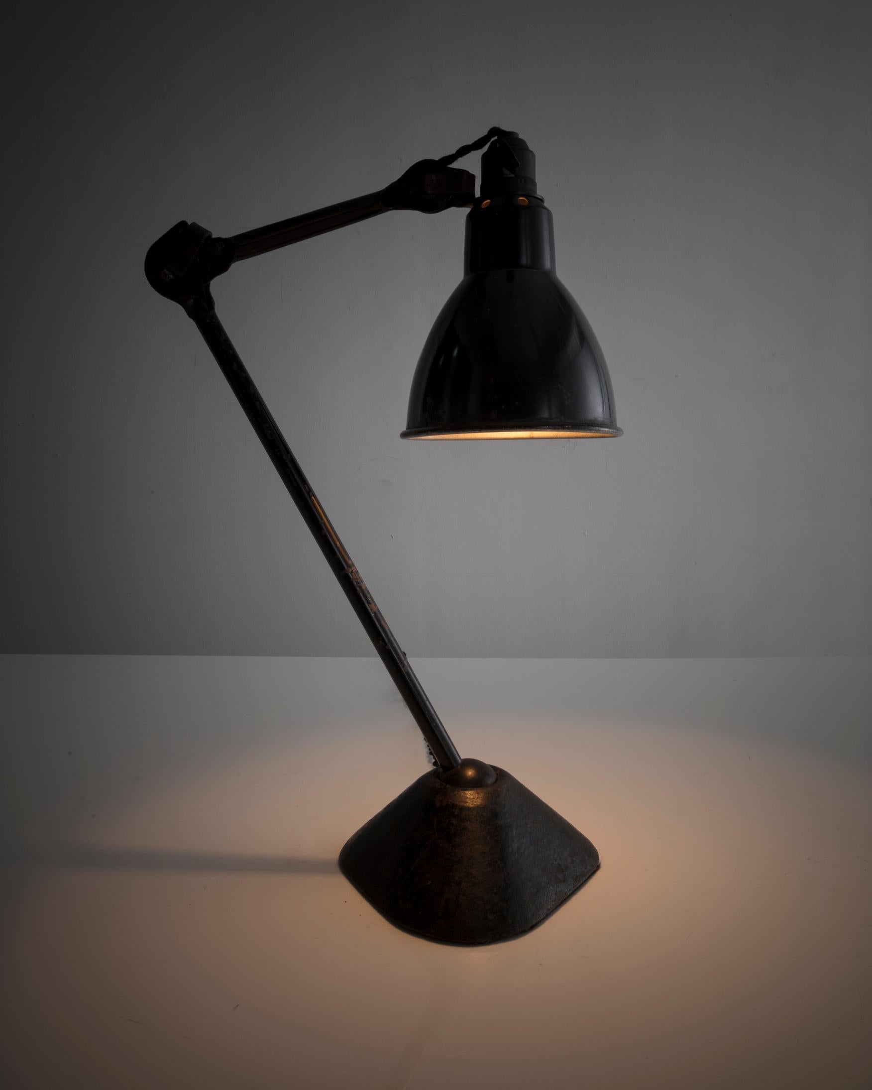 Table lamp in black metal with triangular base. Designed by Bernard-Albin Gras for Les Ateliers Gras, France, 1920s (height is variable).
 