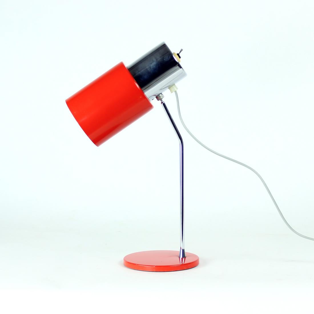 Beautiful table lamp produced in the Mid-Century Modern design period. Designed by Josef Hurka for Napako company. Produced in 1960s. Light, elegant design with metal base and shield in bright red color. The constructruction is made of a chrome rod