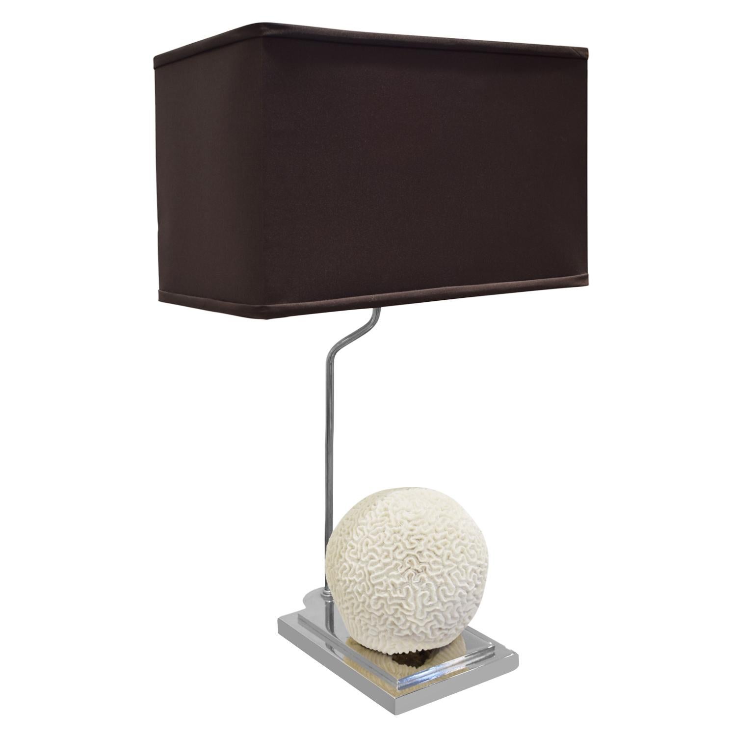 Table lamp in chrome with brain coral formation sitting on platform, American, 1970s. Lamp shade is brown. This lamp is very chic.

Measures: Shade W 16.5 inches
Shade D 9.5 inches.