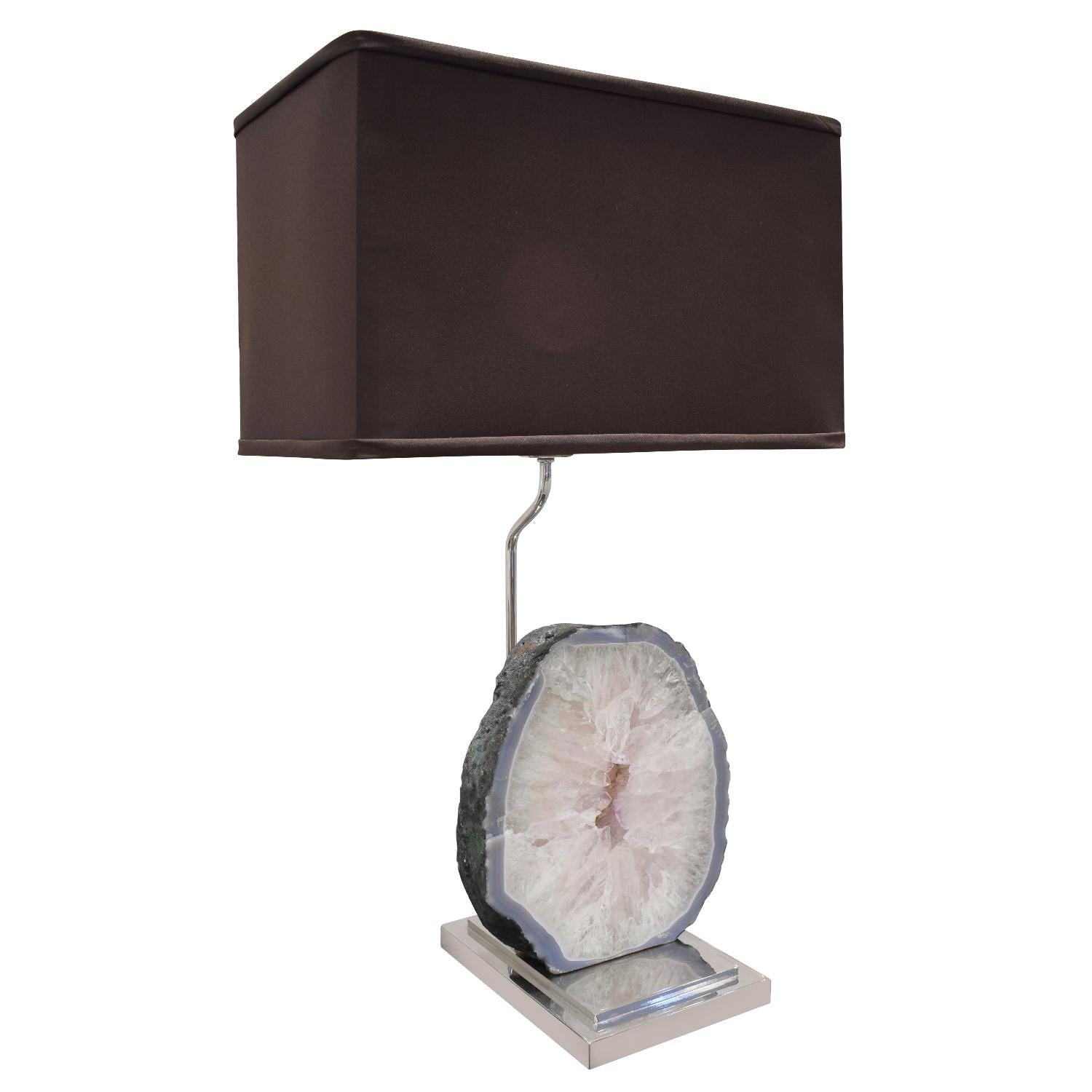 Table lamp in chrome with polished slab of stunning quartz sitting on pedestal base, American, 1970's. The mixture of metal with the polished quartz is very chic.

Measures: Shade W 16.5 inches
Shade D 9.5 inches.