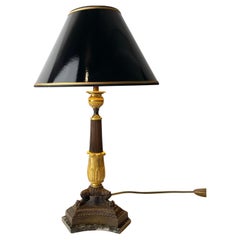Antique Table Lamp in gilded and dark patinated bronze with marble base. Empire 1820s