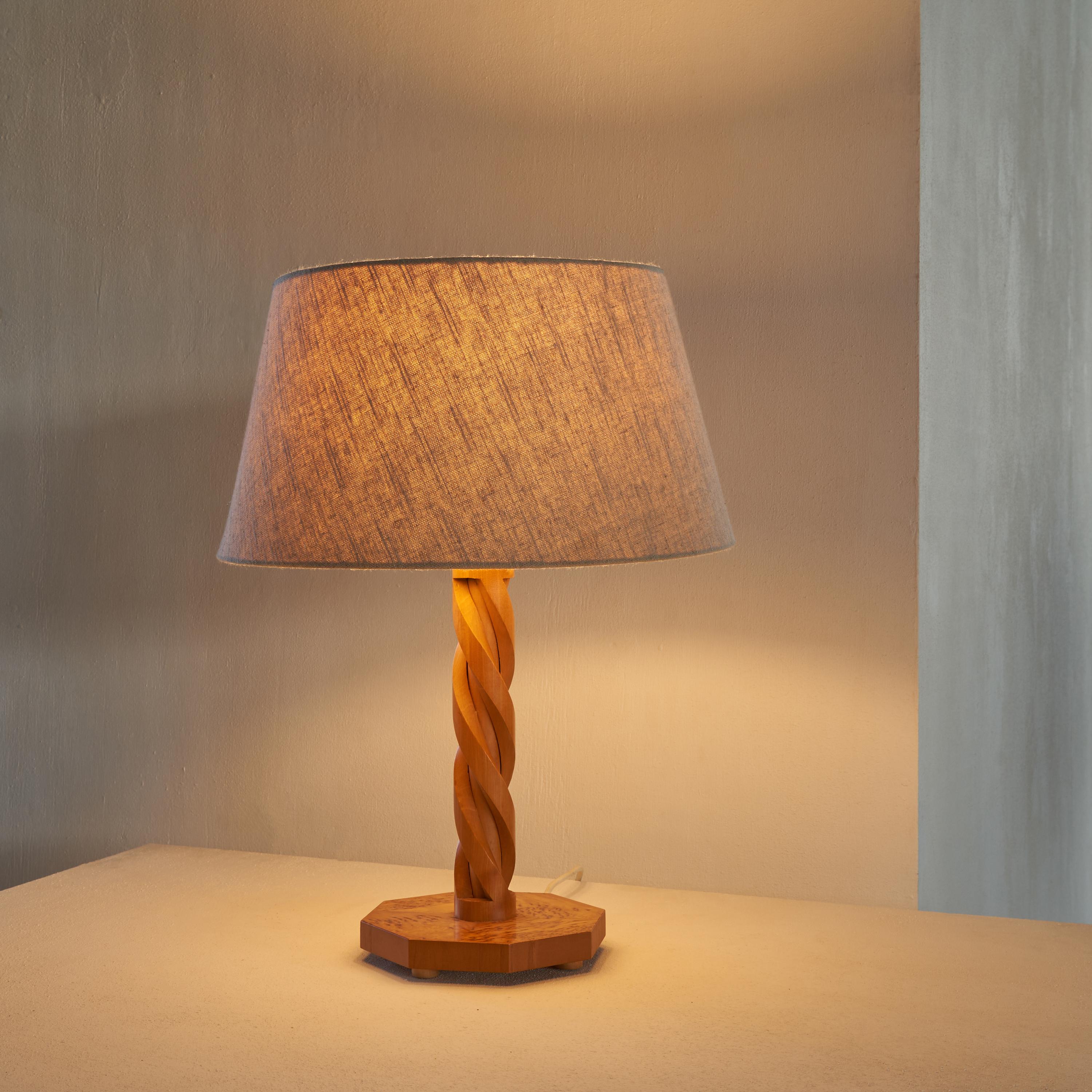Table Lamp in Hand Carved Wood and Burl Veneer. Europe, 1988.

This is a unique table lamp with a turned hand carved wooden stem and a base made out of wood and beautiful burl veneer. Almost certainly this is a one-off piece made by a craftsman. A
