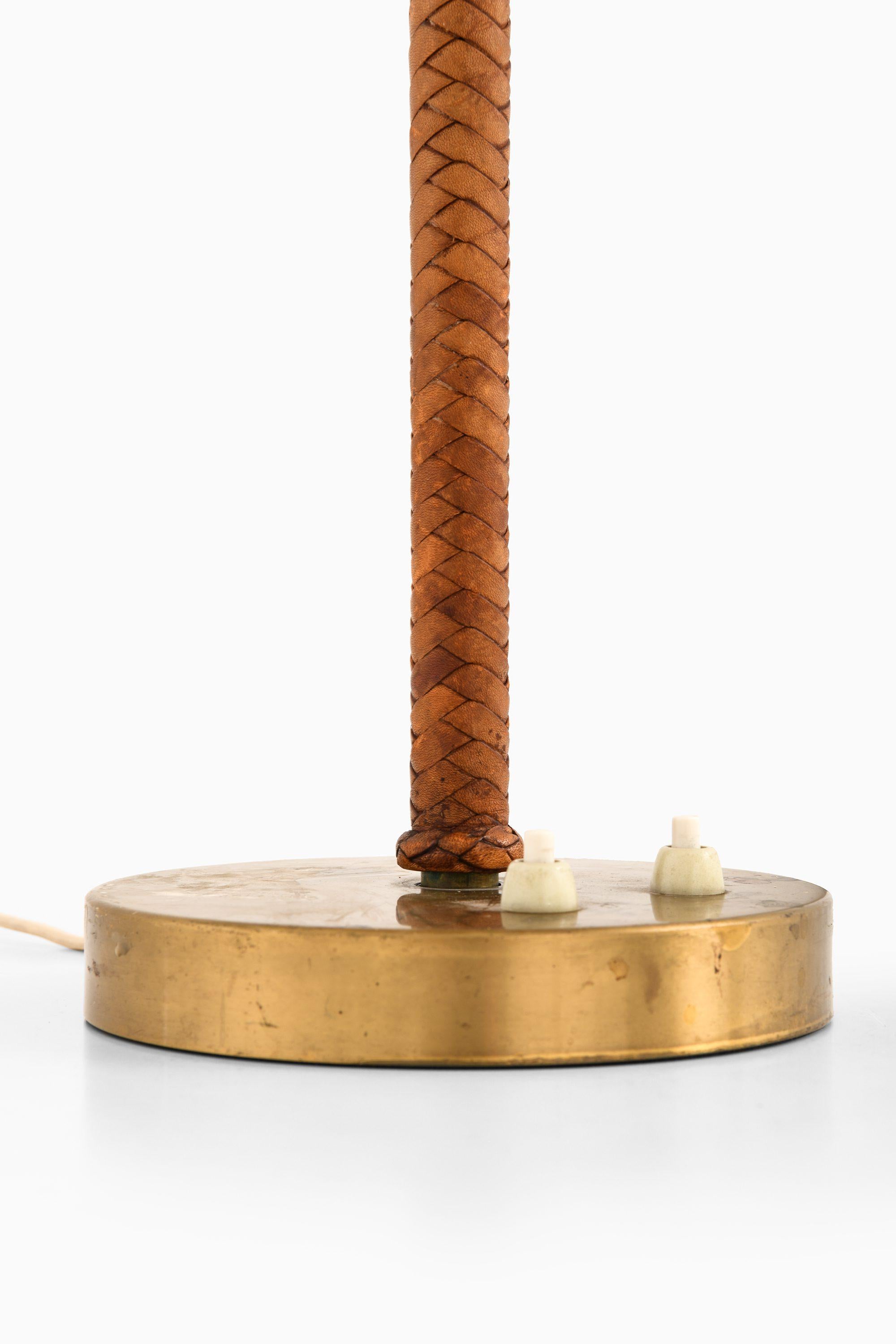 Table Lamp in Leather, Brass and Original Lamp Shade by Bertil Brisborg, 1950's

Additional Information:
Material: Leather, brass and original lamp shade
Style: Mid century, Scandinavian
Produced by Nordiska Kompaniet in Sweden
Dimensions (W x D x